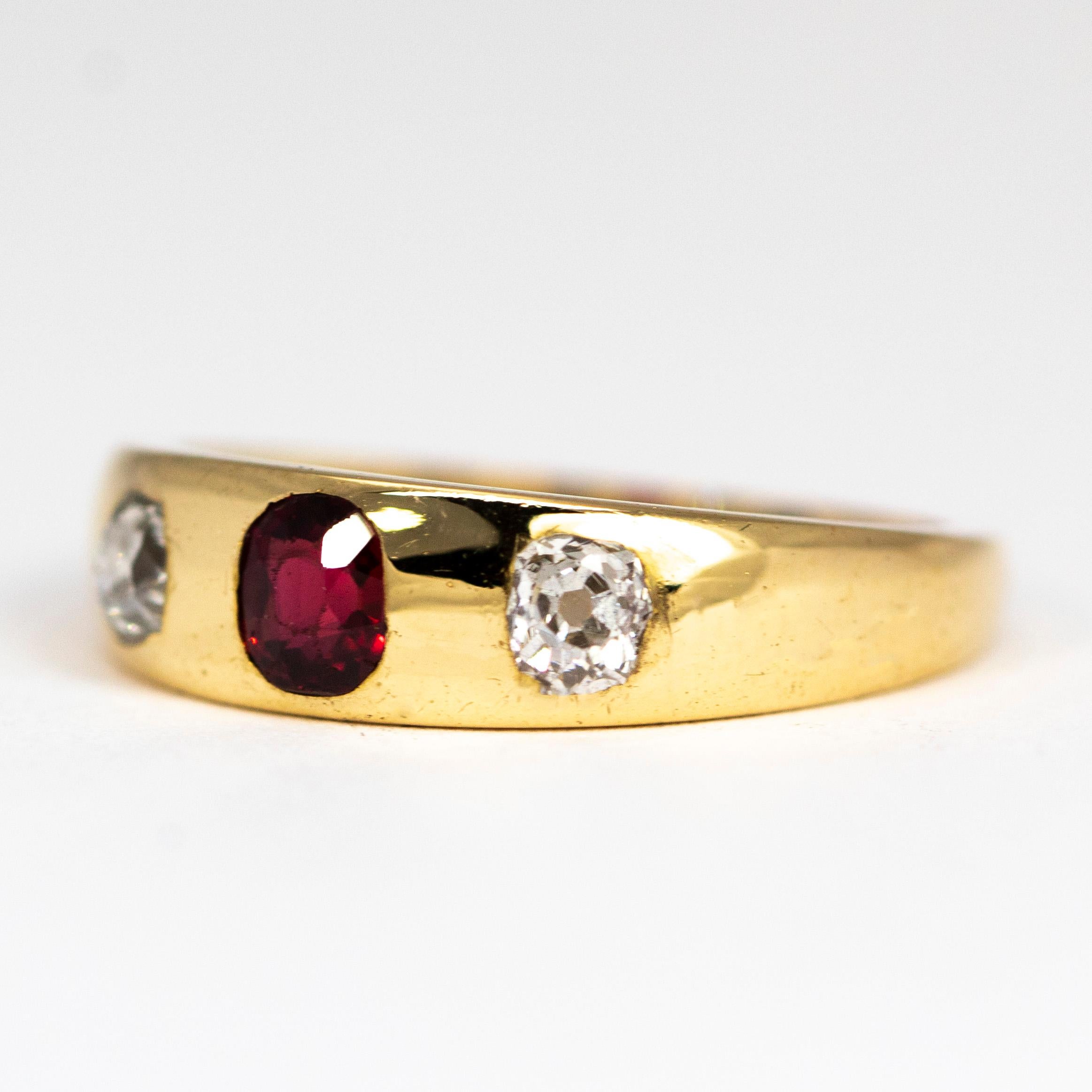 This stunning glossy gold band holds a fabulous deep red ruby measuring 30pts and either side of this stone sit a 20pt diamond which add a wonderful glistening aspect to the ring. The stones sit flush in the band 18ct gold. 

Ring Size: L 1/2 or 6
