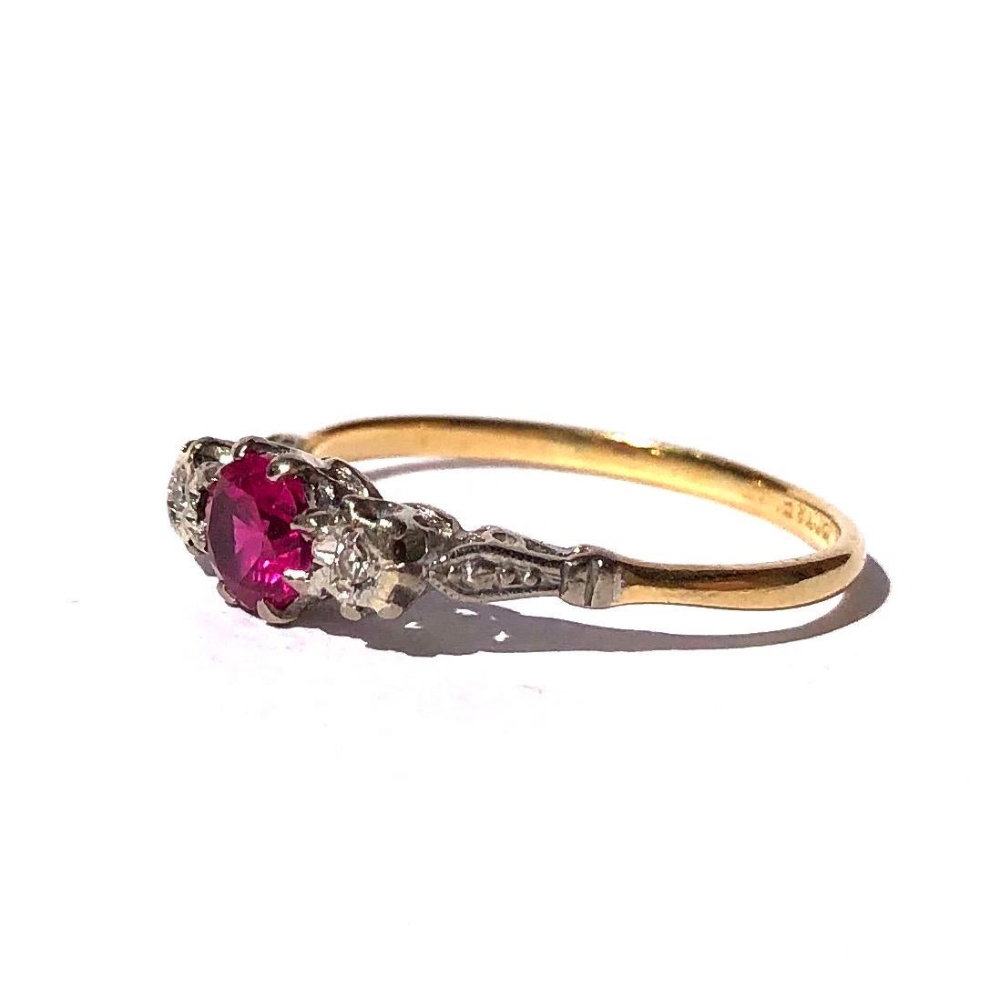 At the centre of this sparking trio is a bright 50pt ruby which is the prettiest shade of pink! The diamonds either side are bright and measure 3pts each. The stones are all set in platinum and the rest of the ring is modelled in 18ct gold. 

Ring