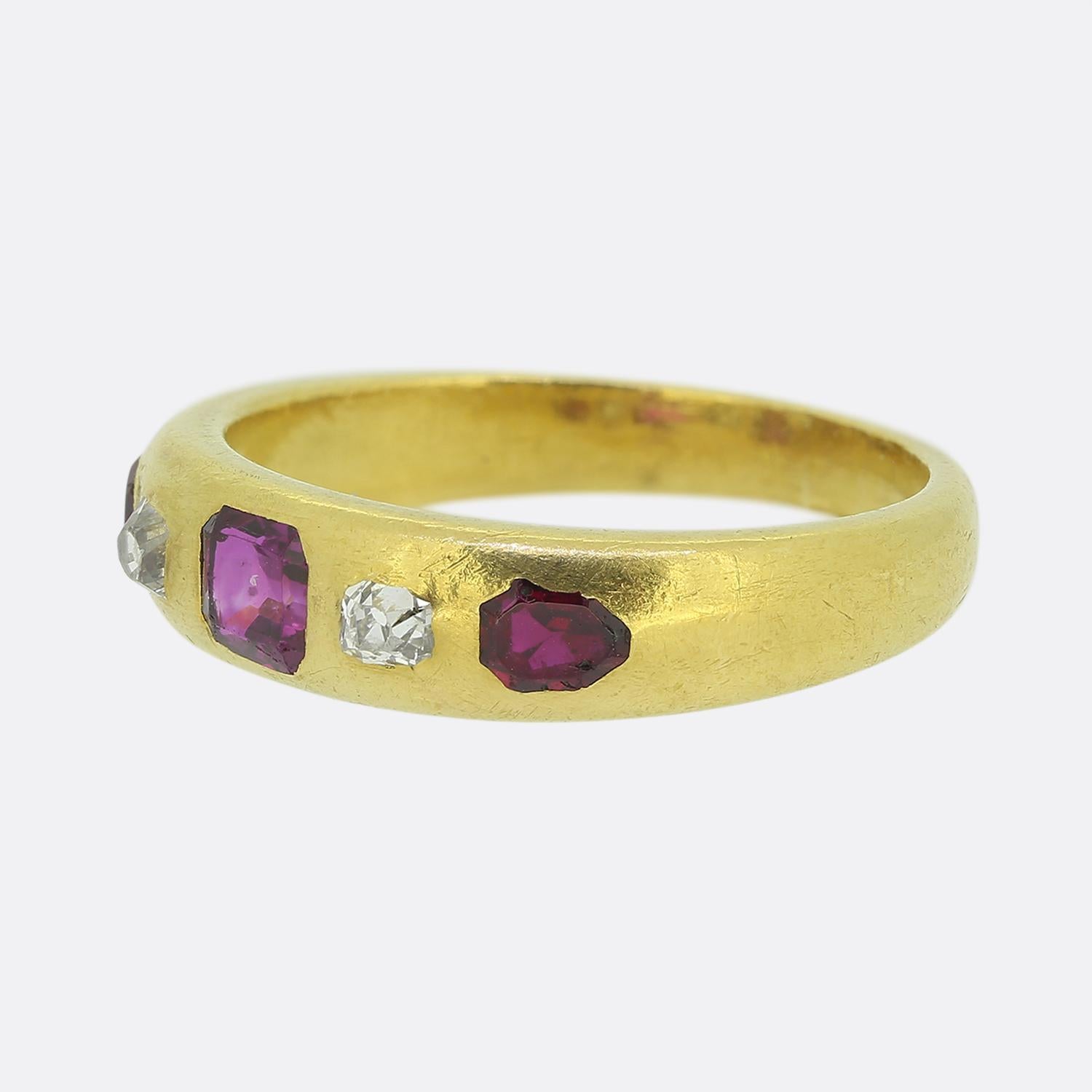 Here we have an 18ct yellow gold ruby and diamond gypsy ring. The piece dates back to the early 1900s and showcases three rubies and two old cut diamonds. The stones are flush set and the mid to dark red of the rubies is highly complimented by the
