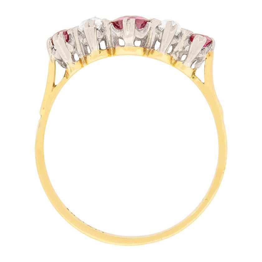 Sparkling pink rubies and white diamonds make up this five stone ring. The centre ruby weighs 0.40 carat, whilst the two on either end each weigh 0.10 carat. They are natural stones, with two old cut diamonds set in between them. The diamonds each