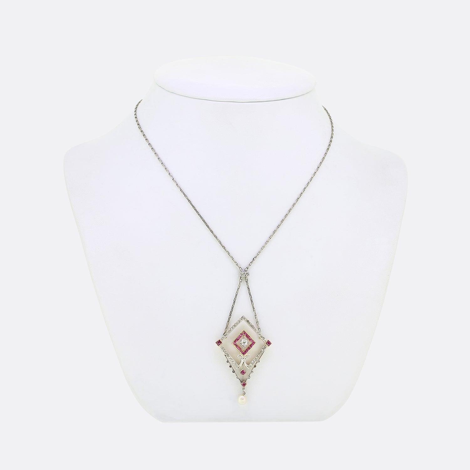 Here we have a excellent platinum and 18ct gold necklace from the Edwardian era. An open geometric frame plays host to a row of rose cut diamonds around the outer edge in a fine milgrain detailing. Square shaped rubies possessing a lovely pinky red