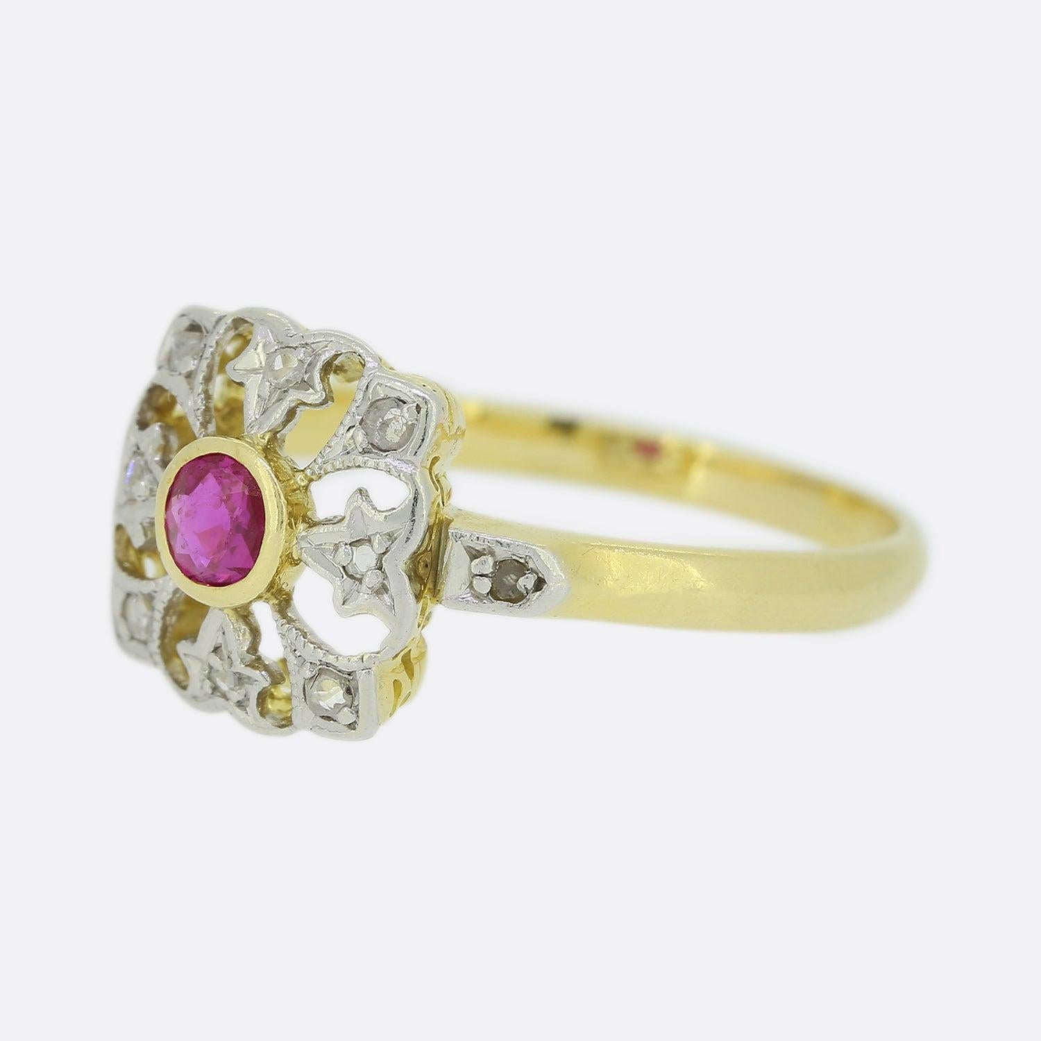 Here we have an antique ruby and diamond ring from the Edwardian era. The head of this piece has been openly crafted and showcases a centralised rub-over set pink ruby. Accentuating this focal stone is an array of rose cut diamonds; all of which