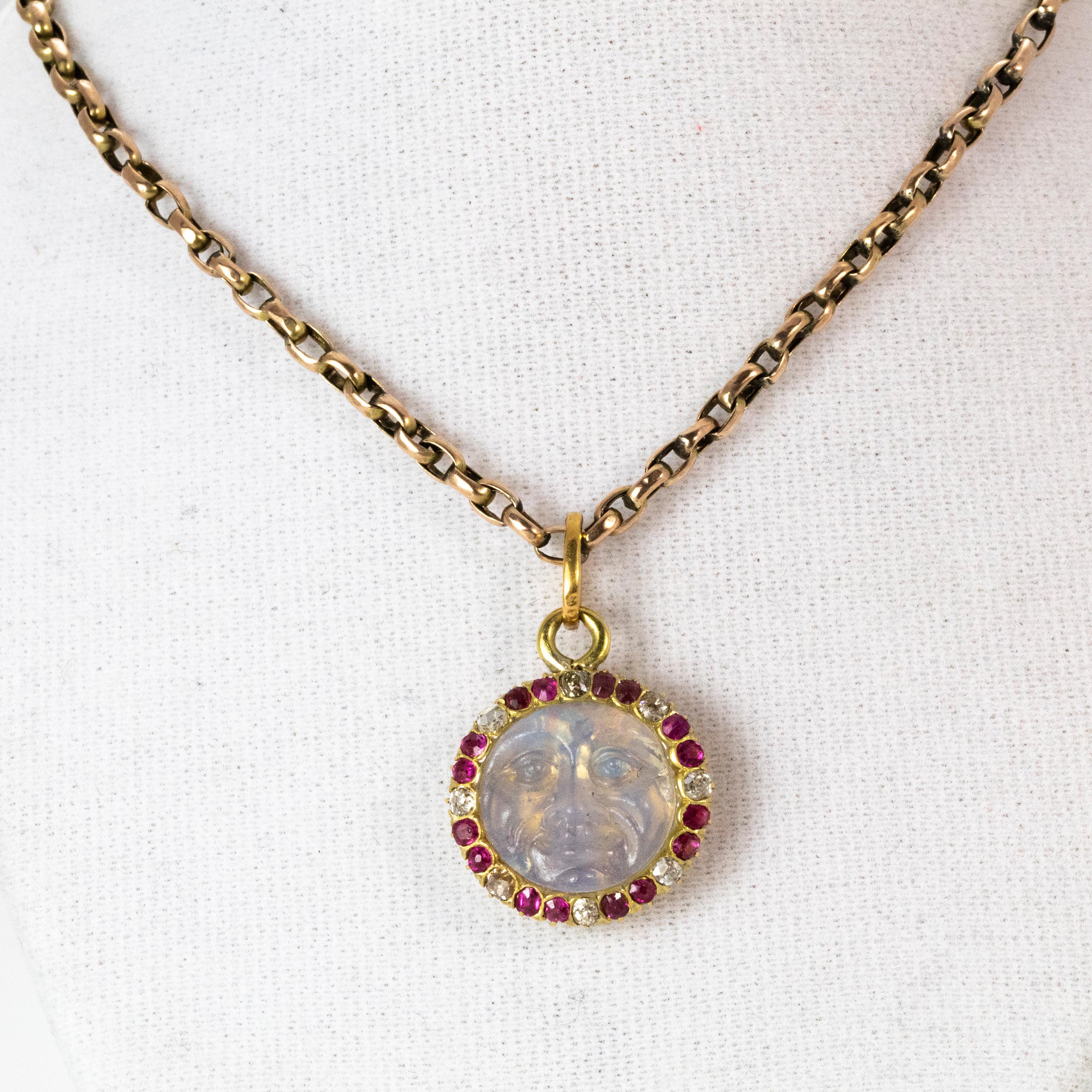 An incredible antique 'Man in the Moon' pendant from the Edwardian era. The focal point of this piece is the masterfully crafted moonstone face, which is surround by a ring of alternating rubies and diamonds on a 9 karat yellow gold belcher link