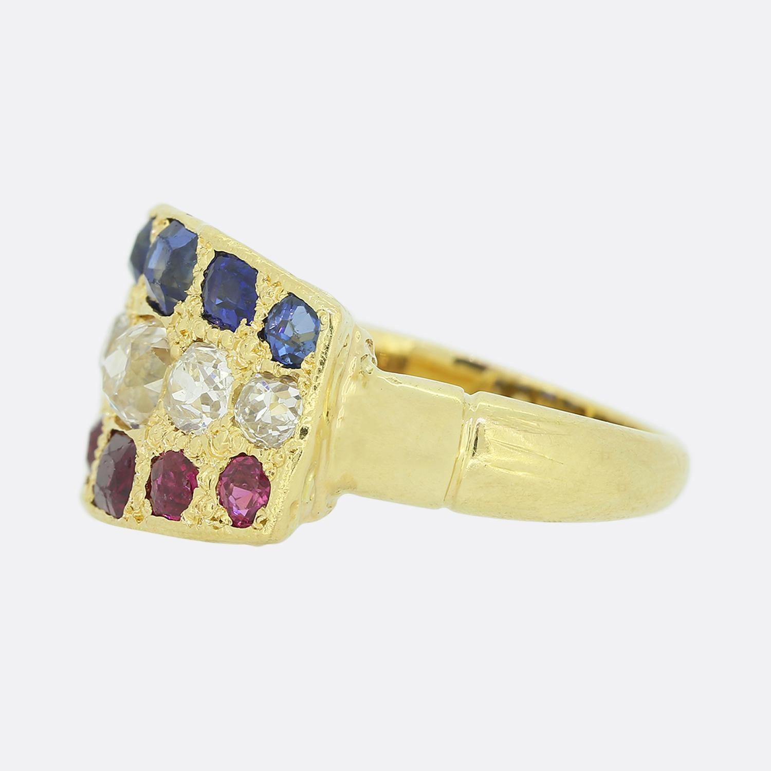This is an Edwardian 18ct yellow gold three row ring. The ring features 5 rubies, 5 diamonds and 5 sapphires, each of which graduate in size to the centre. All of the stones are old cuts and the bright white sparkle of the diamonds is highly