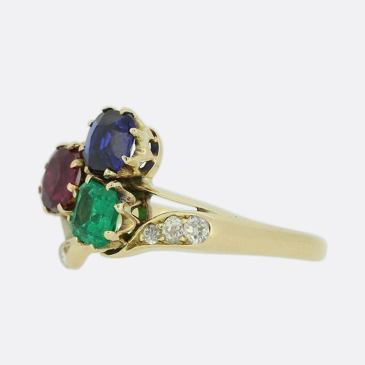 This is a lovely Victorian 18ct yellow gold ring. The ring features a shamrock centrepiece that has been made up of three exceptional quality gemstones. All of the stones are untreated and the emerald is Colombian, the sapphire is Burmese and the