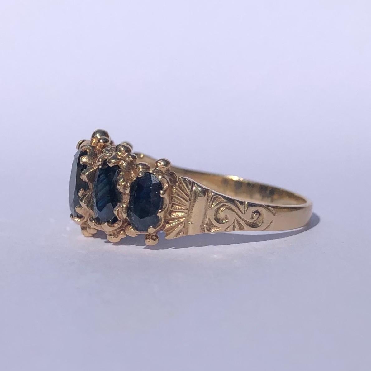 The style if this five stone ring has an almost Indian feel to it. the bright yellow 9ct gold next to the deep inky blue sapphires is gorgeous. The edges of the band has tiny orb detail and The shoulders have gorgeous fan and scroll detail. Made in