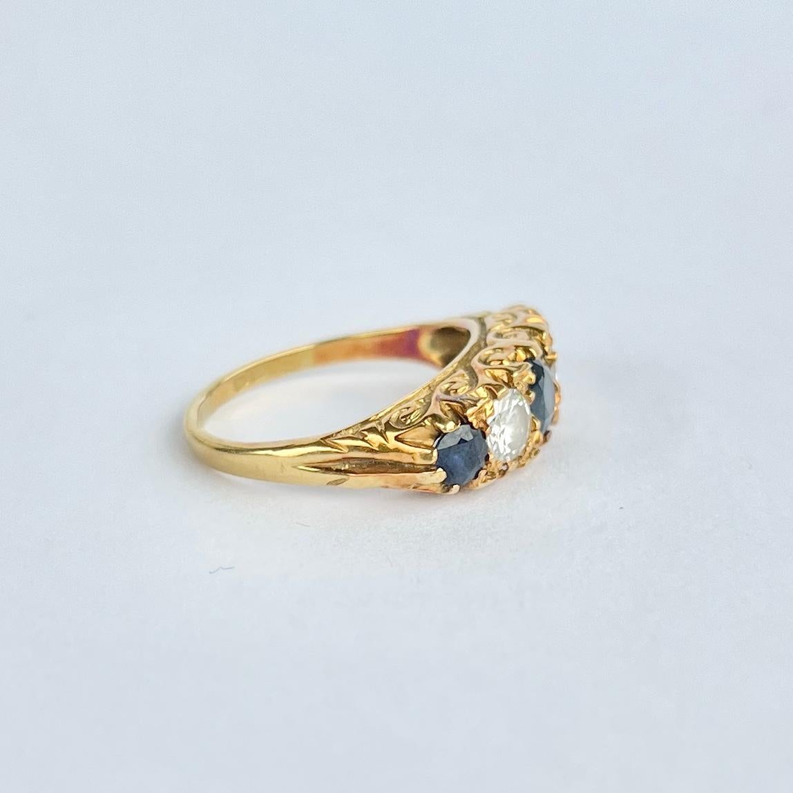 This gorgeous ring holds three deep blue sapphires. The central sapphire measures 40pts and the outer sapphires measure 15pts each. The diamonds between these blue stones measure 30pts each. Modelled in 18carat gold. Fully hallmarked London