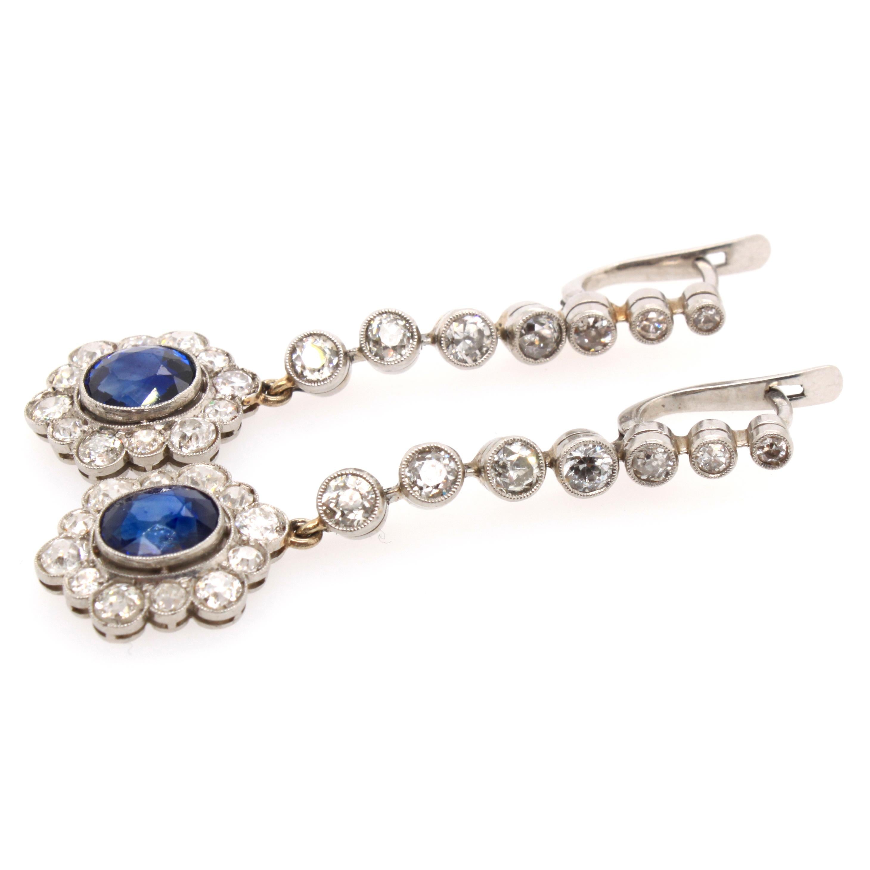 A pair of beautiful Edwardian earrings with sapphire and diamonds, ca. 1910s. The sapphires weigh approximately 3.6 carats and have a strong blue colour. They are surround by an old cut diamond cluster, which oscillates from the top by a line of old