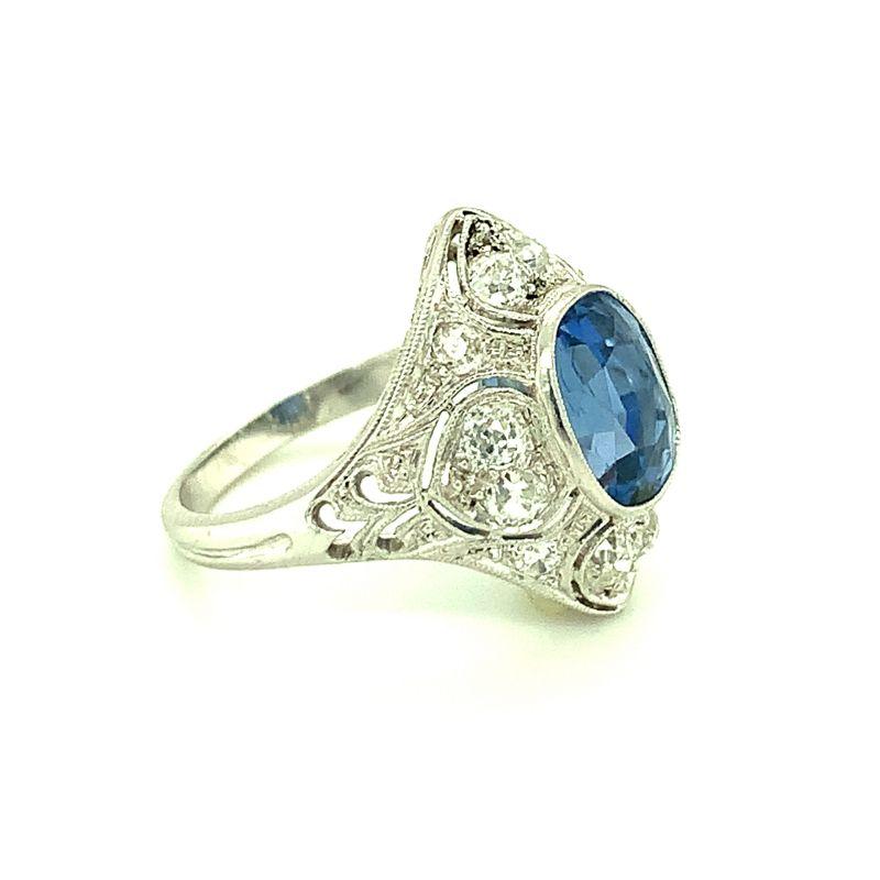 One Edwardian sapphire and diamond platinum ring featuring a marquise-shaped design mount centering one oval sapphire weighing 3.50 ct. Enhanced by twelve old European cut diamonds totaling 0.75 ct. Circa 1910.

Enthralling, mesmerizing,