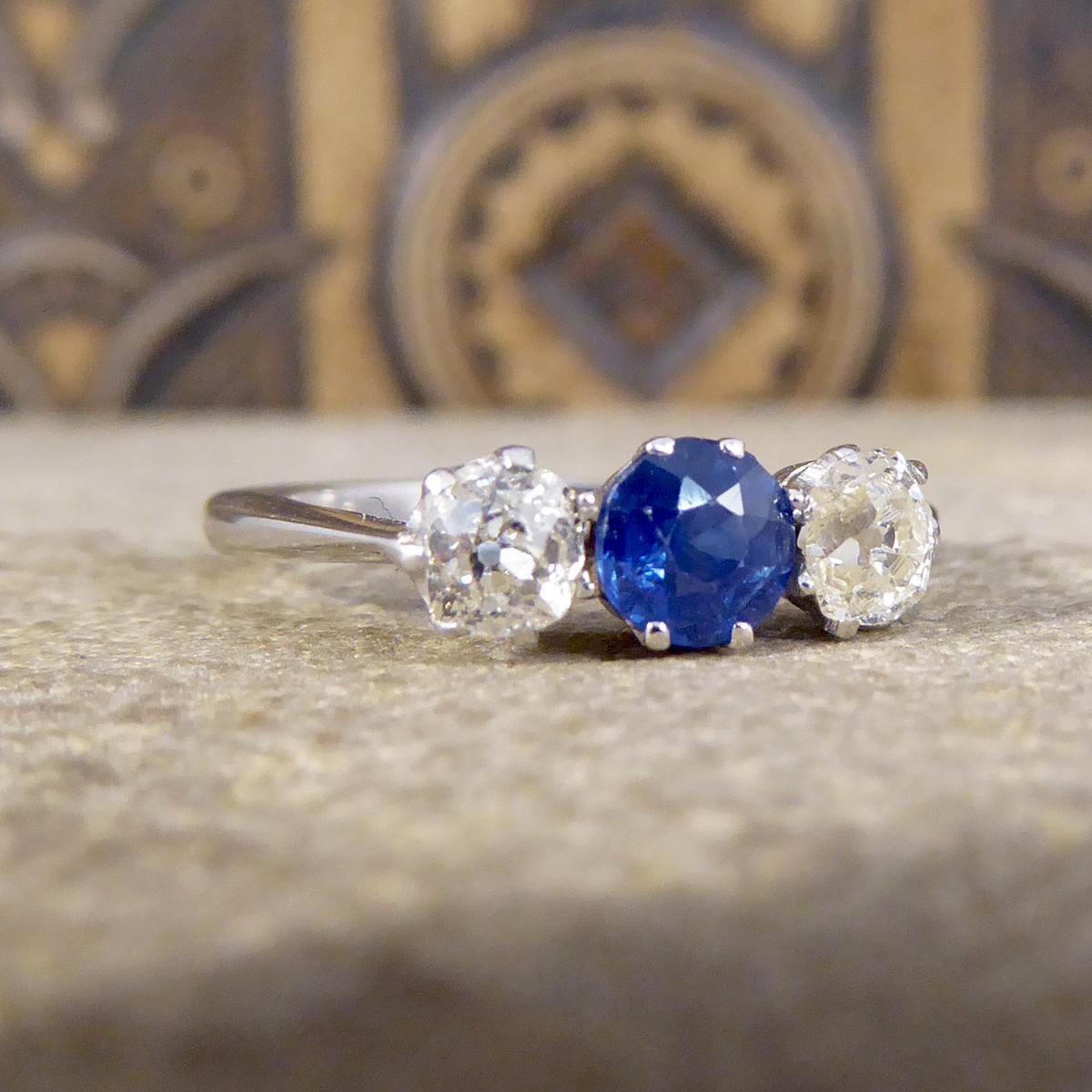 This beautiful three stone ring has been crafted in the Edwardian era and set in a Platinum eight claw setting. It features a beautifully cut Sapphire centre weighing approximately 0.40ct with two Old Cut Diamonds either side weighing a total of