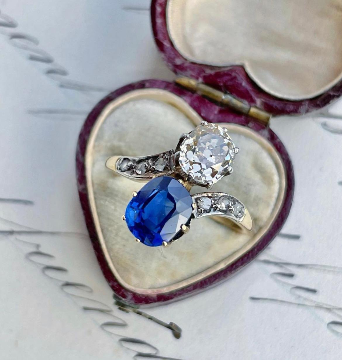This romantic Edwardian era toi et moi ring features a velvety blue 1.63 carat natural, unheated sapphire seated side-by-side with a 1.10 carat old cushion cut diamond, fabricated in platinum topped 18k gold and nicely finished with rose cut diamond