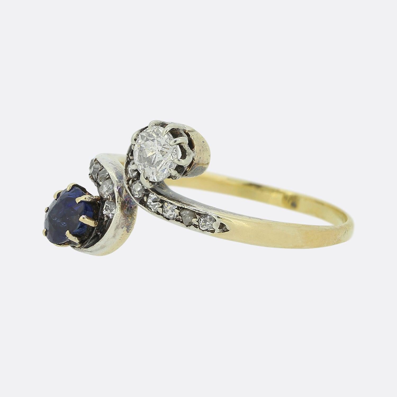 This is an 18ct yellow gold sapphire and diamond ring from the Edwardian era. The ring features a beautiful natural blue sapphire and old cut diamond in a twisted style setting crafted in 18ct yellow gold and platinum with diamond set shoulders.