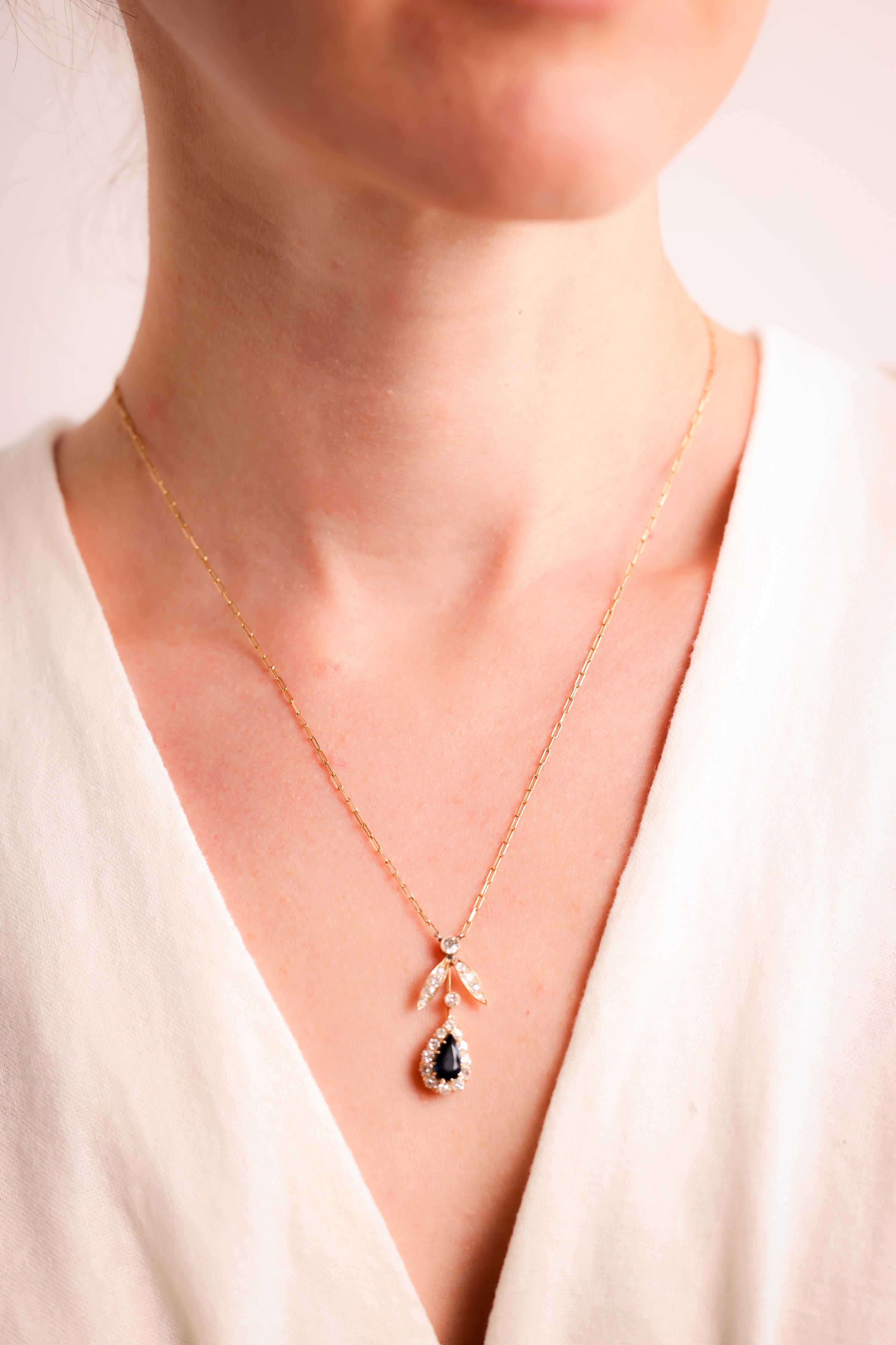 Center Stone: Sapphire
Cut: Pear
Weight: Approximately 1.2 Carats
Color: Deep Blue
Accent Stone: 22 Diamonds
Cut: Round Brilliant, Old Mine
Weight: Approximately 1.5 Carats
Color: H
Clarity: SI
Metal: 18K Yellow Gold
Era:  Edwardian
Circa: Pendant