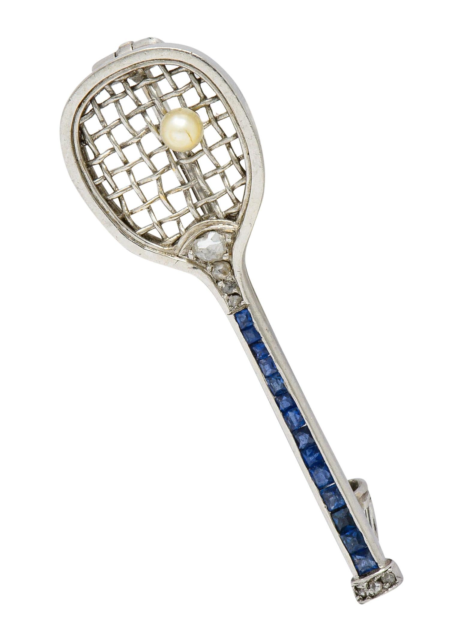 Bar style brooch designed as an antique tennis racket

Hand woven platinum wire net cradles a 3.0 mm round pearl; cream with good luster

Handle is channel set with square cut sapphire and accented by rose cut diamonds

With total weight