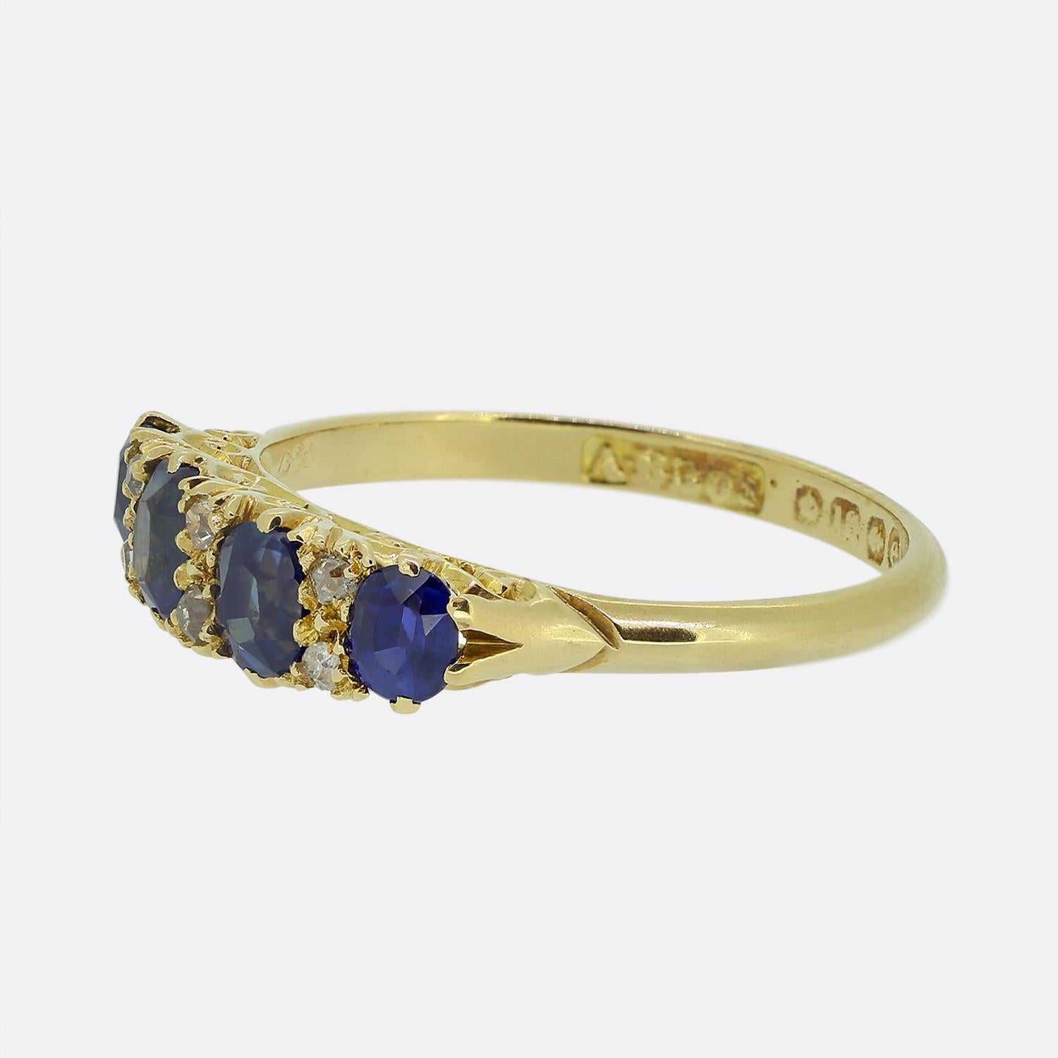 Here we have a lovely sapphire and diamond ring taken from the Edwardian period. This antique piece is crafted from a rich 18ct yellow gold and features four excellently matched oval faceted sapphires, each displaying a deep blue hue. These