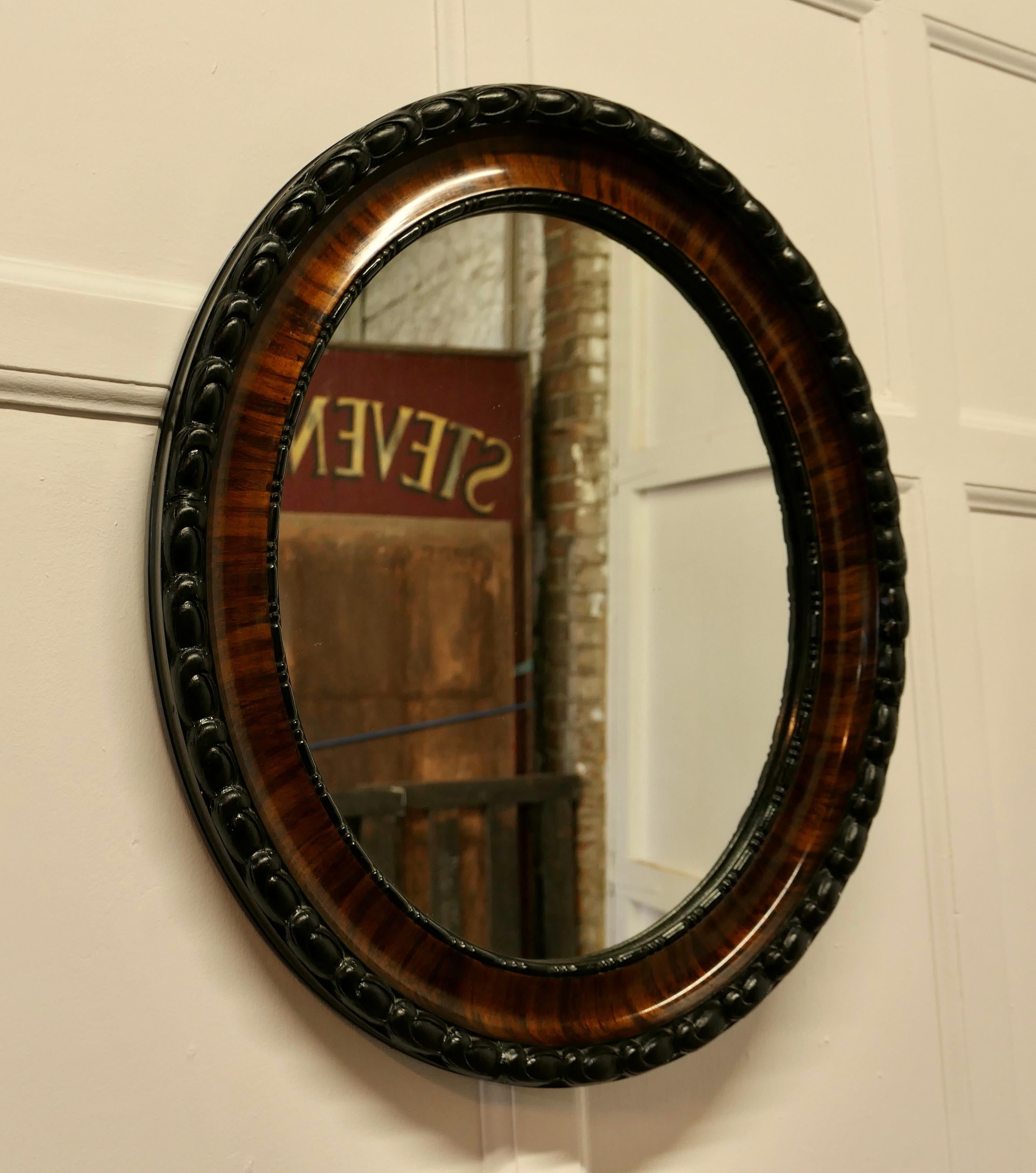 Edwardian scumble finish oval mirror.

This Mirror has a 3” wide moulded oval frame, this has a Scumble simulated Walnut finish, and a heavy Rope carved edge 
The Oval frame is in good attractive condition as is the original Oval looking