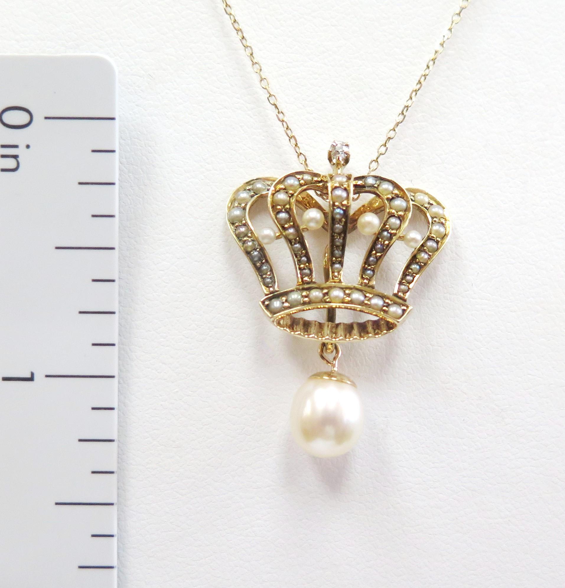 This is a stunning antique 14 karat yellow gold crown pendant. The finely made piece was once a pin that our jeweler converted into a beautiful pendant. This dainty royal charm is embellished with many tiny seed pearls, and 4 larger seed pearls. A