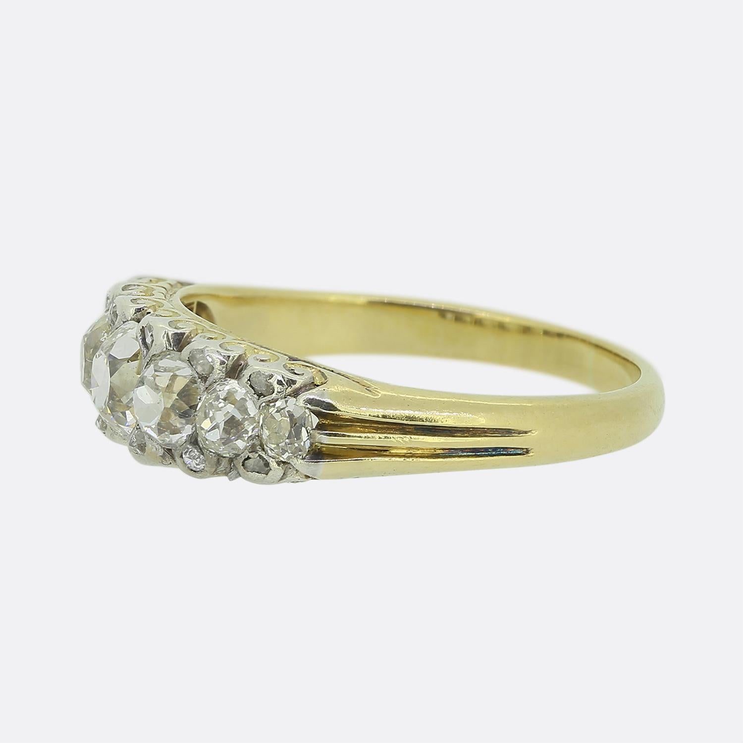 Here we have a classic seven-stone diamond ring dating back to the Edwardian period. This antique piece features seven old mine cut diamonds in a single line formation across the face. Each of these chunky stones has been set in platinum and is