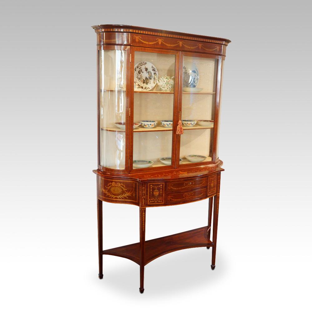 Edwardian Sheraton Revival display cabinet 
This Edwardian Sheraton Revival display cabinet was made circa 1900 and was made in in one of the finest workshops of the day, probably Edwards & Roberts.
The cabinet stands on a base that has square