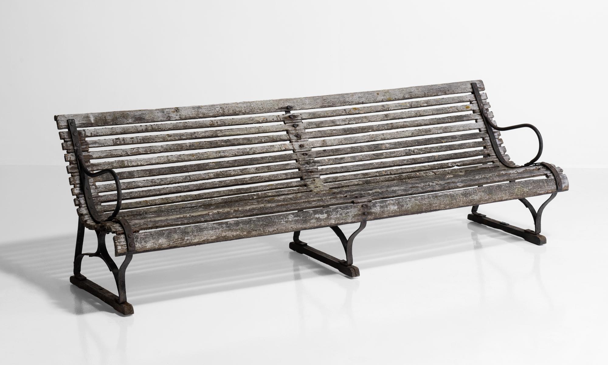 Edwardian ships steamer bench, England circa 1900.

Teak and wrought iron bench, originally made and used on a steamer ship.   
  