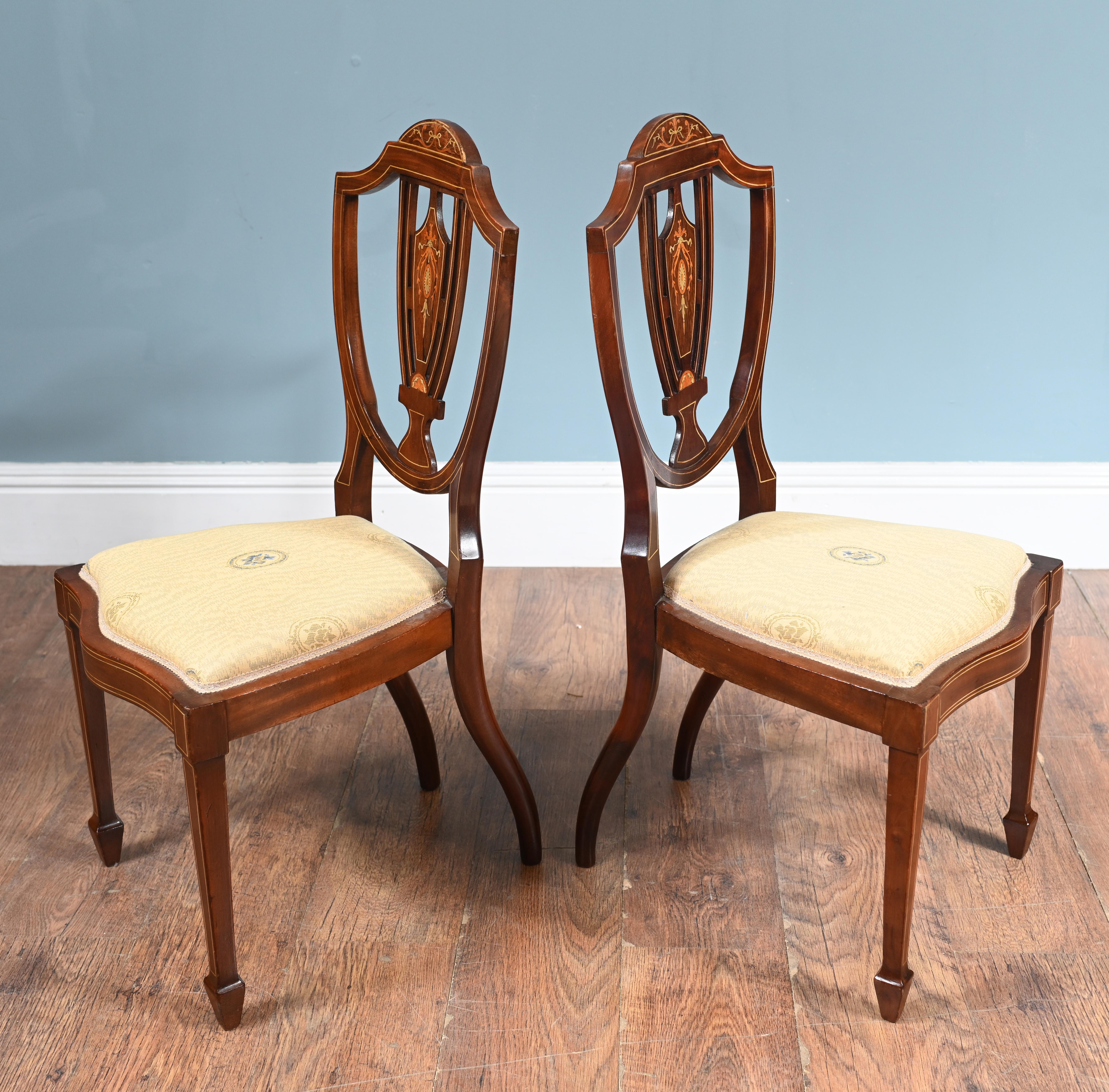 You are viewing a gorgeous pair of Edwardian side chairs in the Hepplewhite manner
Very delicate pair of parlour chairs
The chairs feature a refined shield-shaped back, a hallmark of the Hepplewhite style
The splats are exquisitely inlaid with