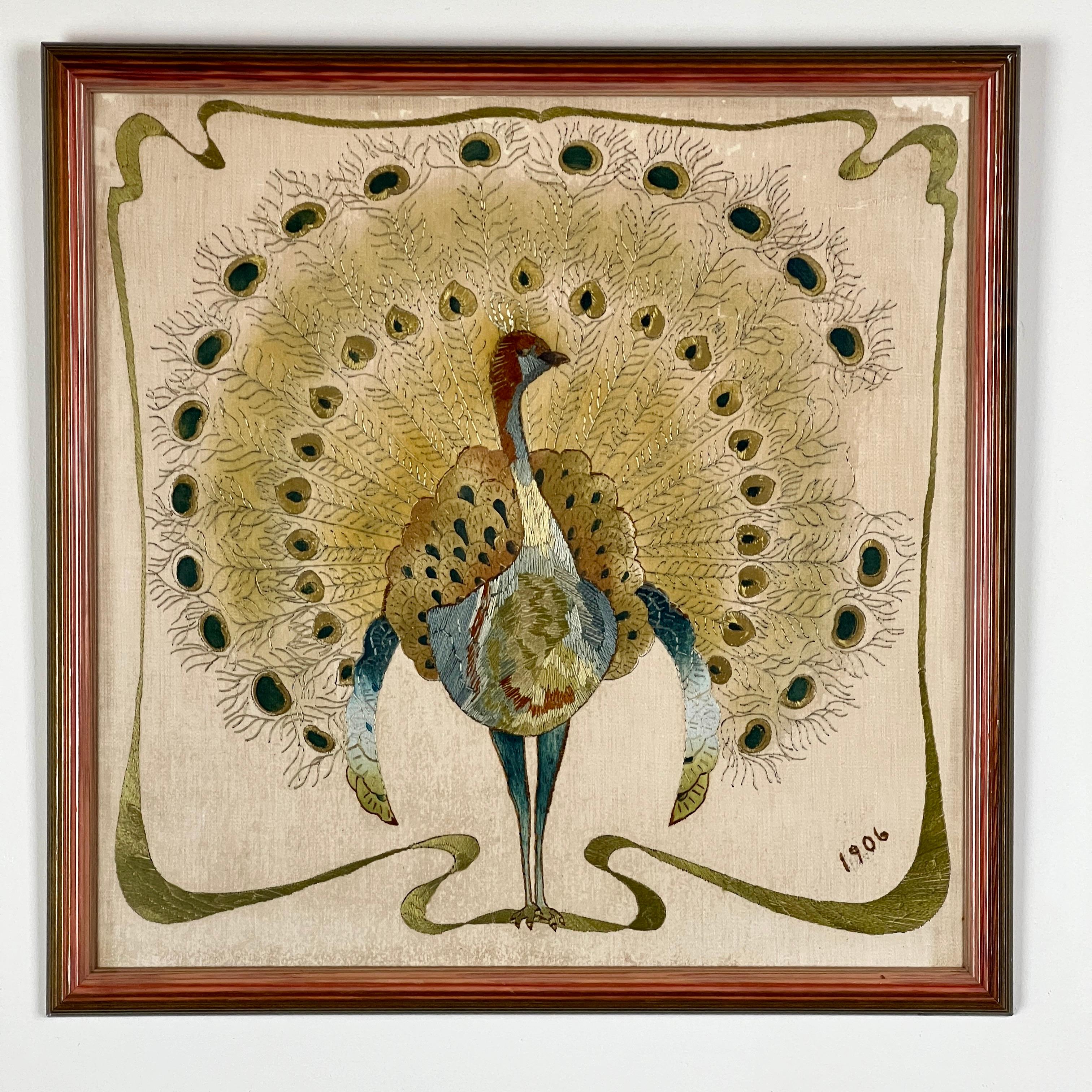A charming Edwardian Silk Embroidery of a Peacock. Hand sewn in silk of a male peacock displaying full plumage Framed and glazed. Dated 1906.