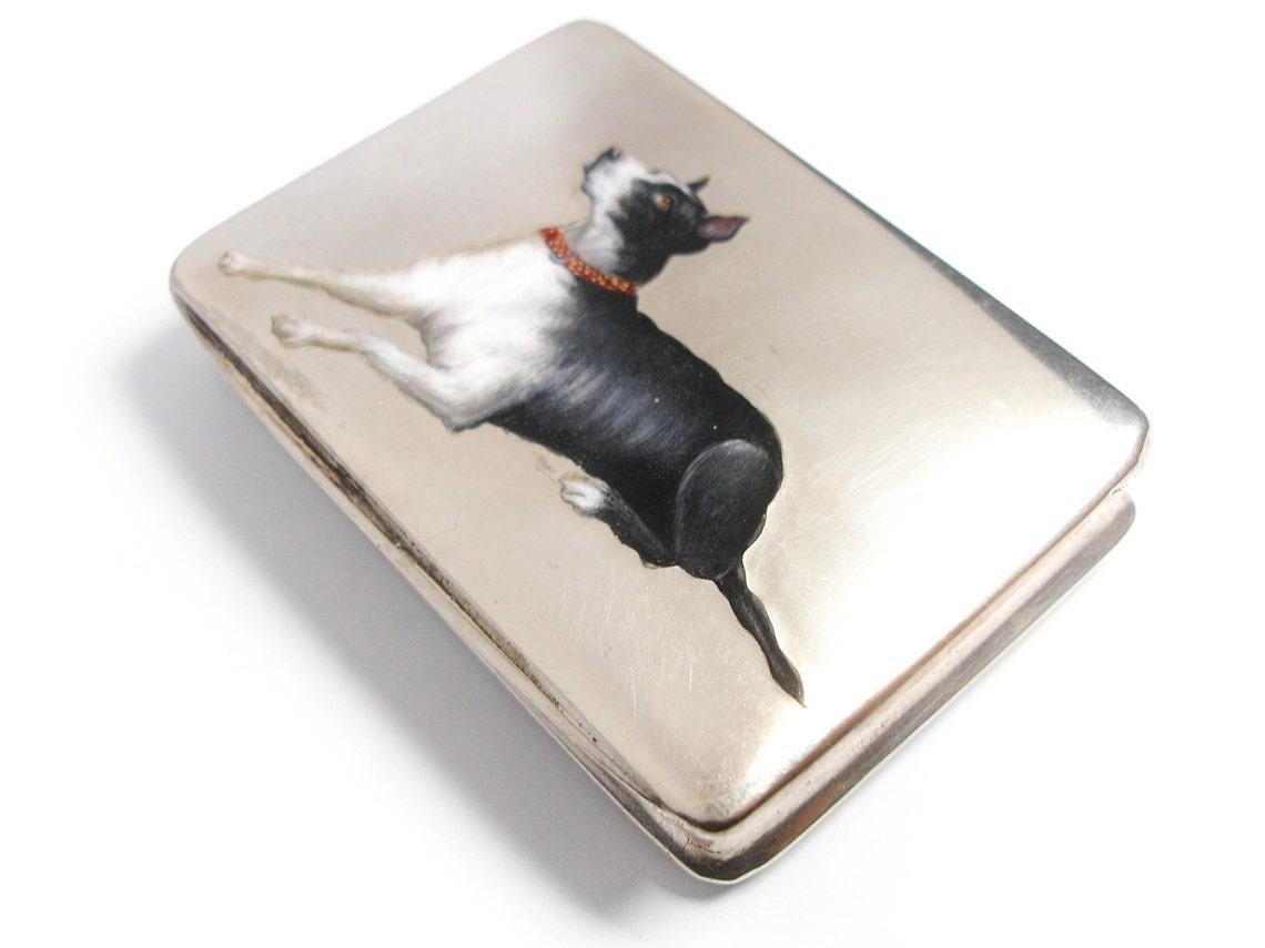 This is a beautiful, antique Edwardian trinket box. It is made from Silver and decorated with a hand painted enamel dog.


Era: Edwardian (1901 - 1910)

Measurements: The box measures 7.3 cm long.

Hallmarks: The Silver is marked 800.

Condition: It