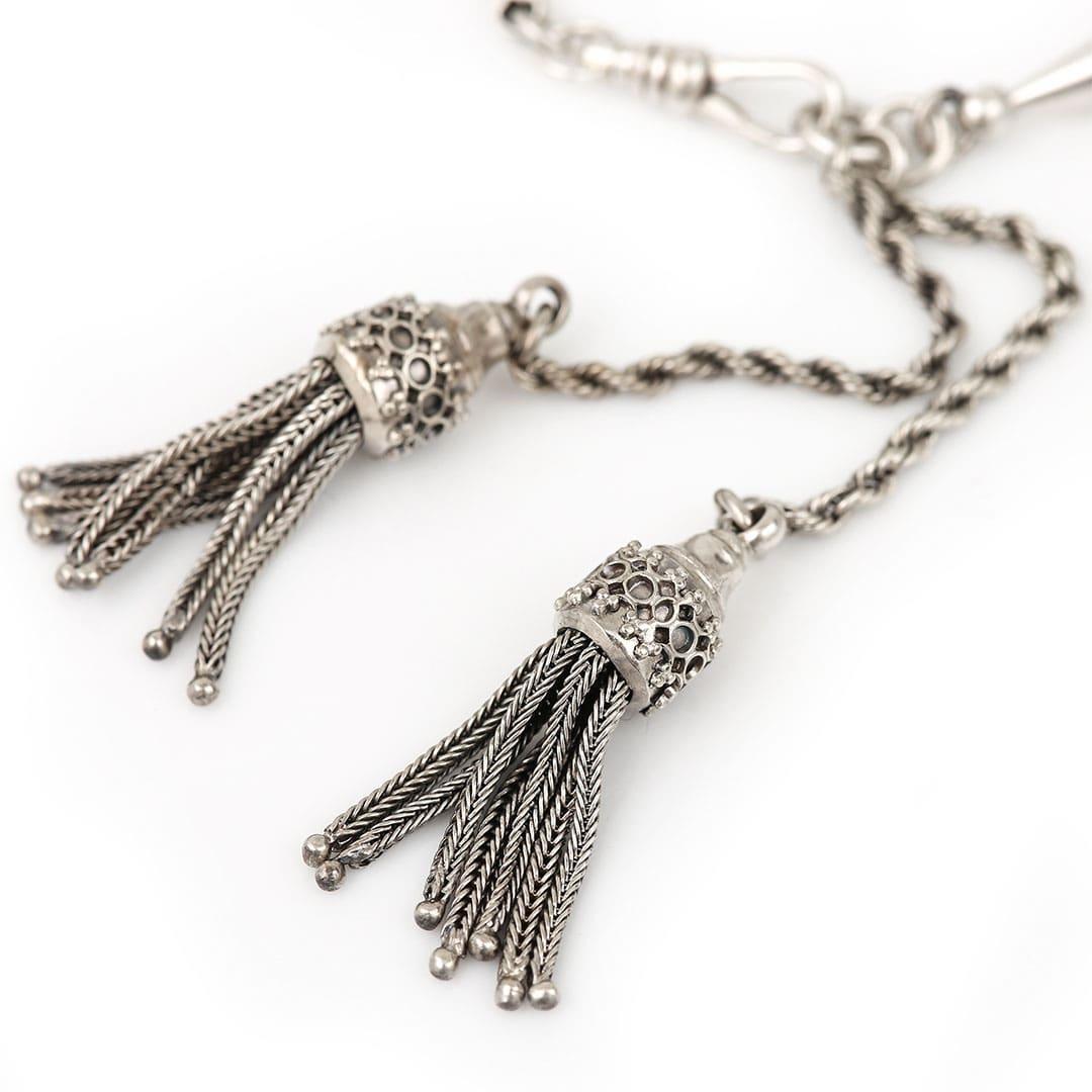A charming silver antique albertina bracelet with two torpedo links and two pretty tassels that hang from the bracelet when worn. Connected by a belcher and rope link chain, this pre-loved bracelet has a swivel clasp with a fixed ornate flat clasp