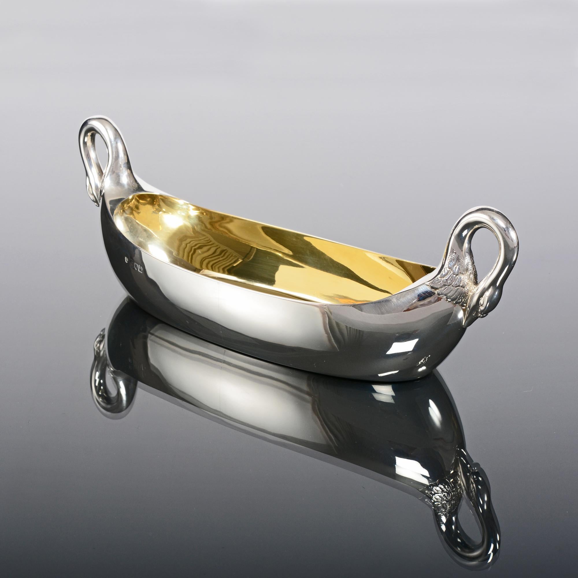 A most elegant boat-shaped silver sweet dish fitted with charming cast and hand chased swan handles and a gilded interior.

Since ancient times, swans have been associated with tranquillity and nobility, featuring in mythology and folklore around