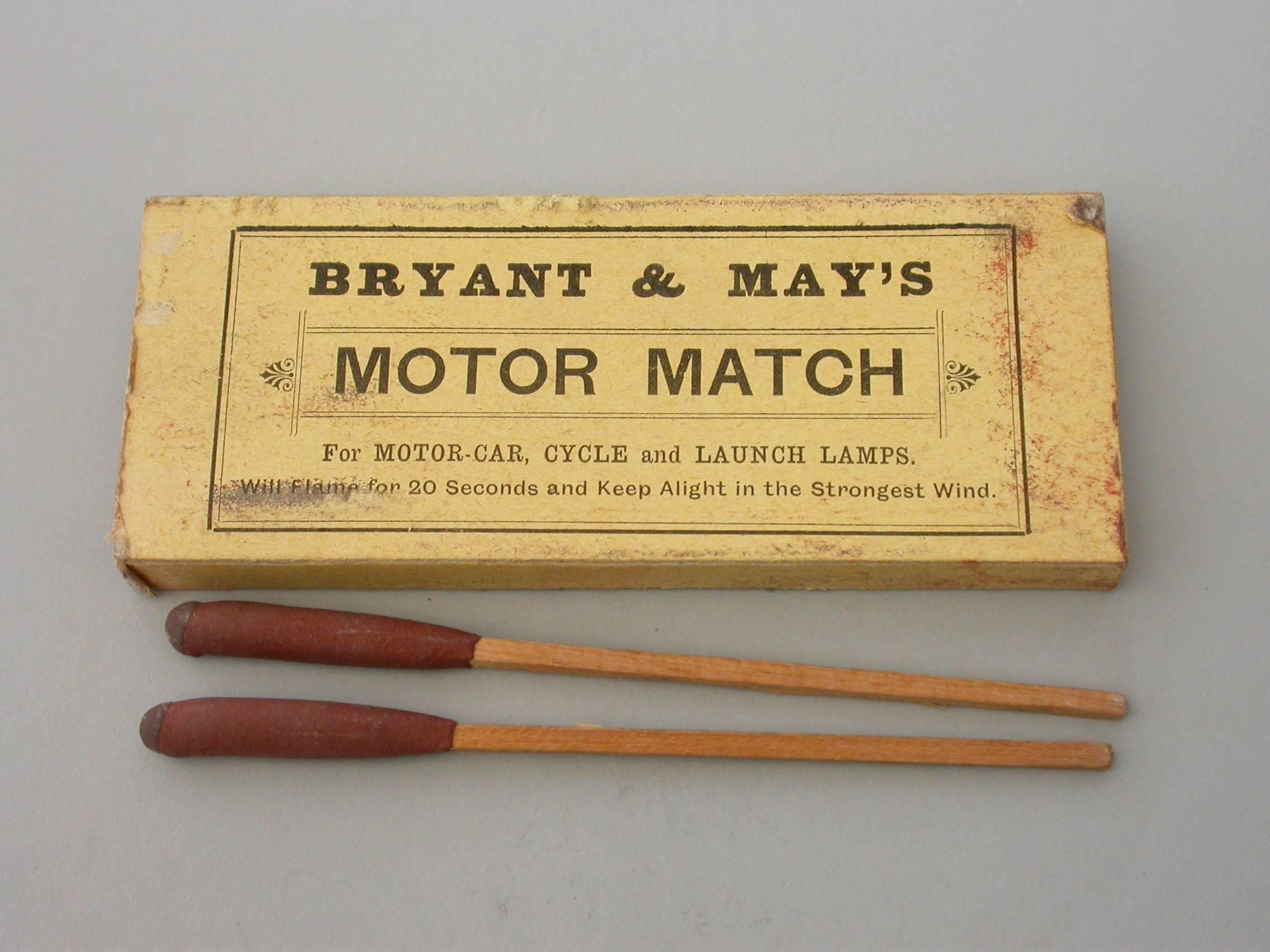 An unusual Edwardian large silver matchbox case of plain narrow rectangualr form with hinged lid and aperture for striking, containing an original box of Bryant & May's 