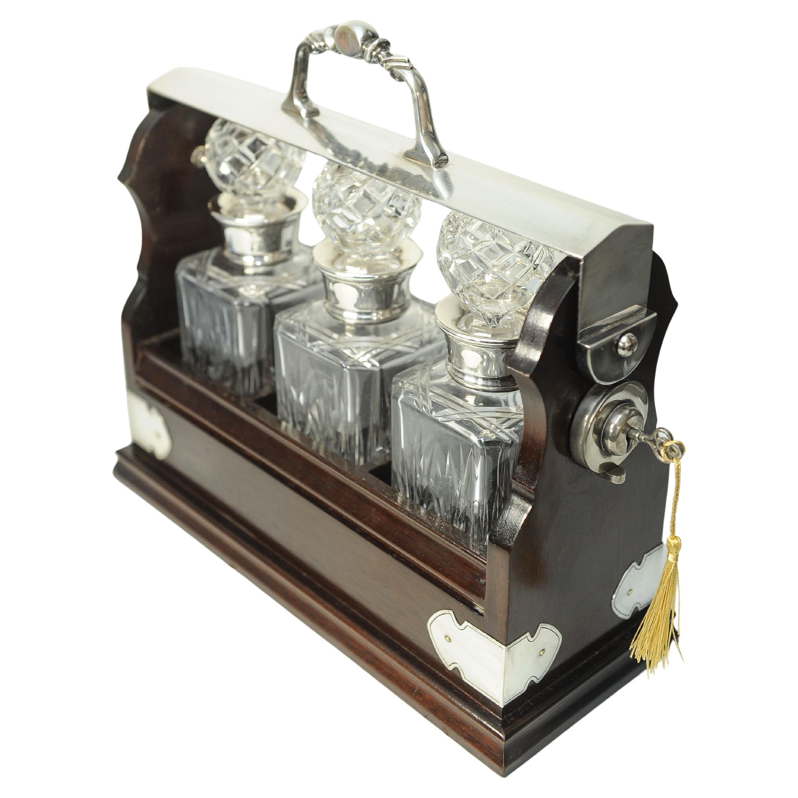 A Edwardian Mahogany Tantalus With A Set of Three Square Cut Glass Decanters

Comes With A Working Key With A Gold Silk Decorative Tassel.

Decanters will be different from what is depicted, will be sold with three cut glass decanters. 


