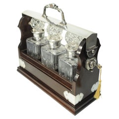 Edwardian Tantalus With A Set of Three Square Cut Glass Decanters