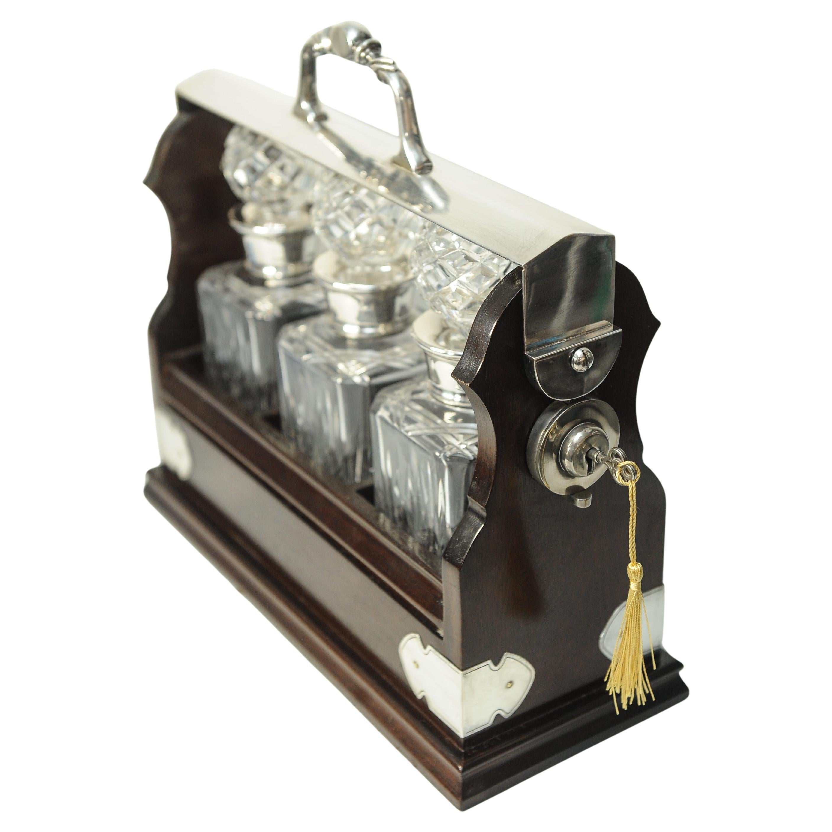 British Edwardian Tantalus With A Set of Three Square Cut Glass Decanters For Sale