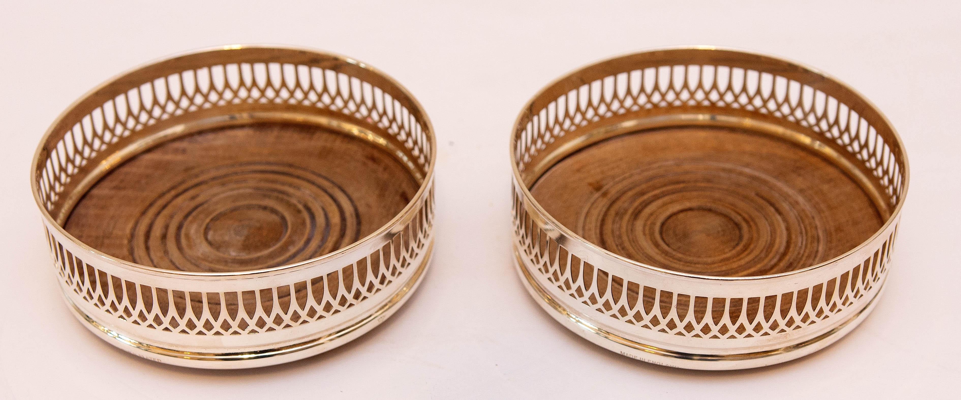 Pair of antique English silver plate wine coasters. Wood bottoms, early 20th century.