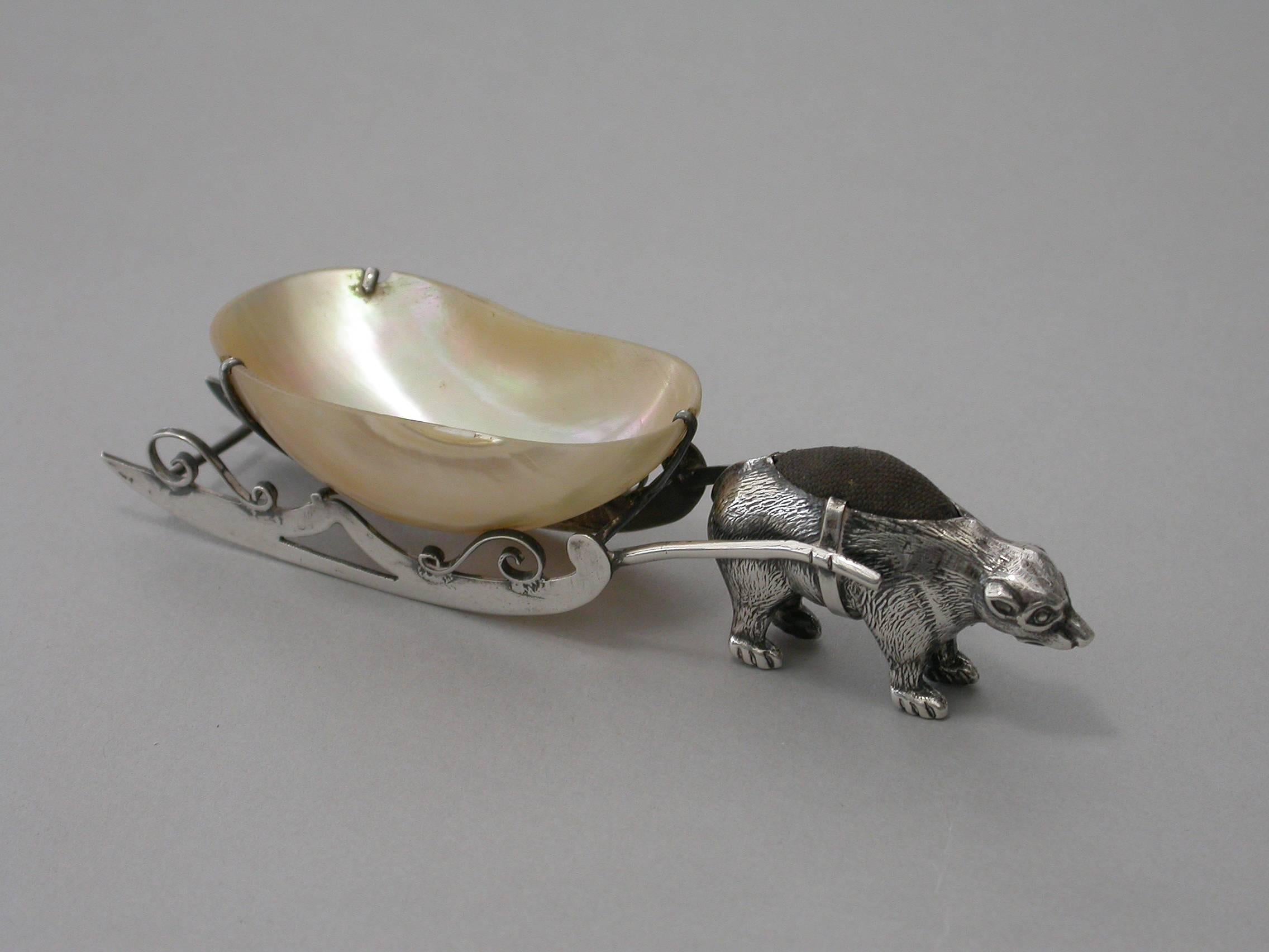An extremely rare Edwardian silver pin cushion depicting a polar bear pulling a silver mounted mother-of-pearl pin tray made in the form of a sleigh.

By Robert Pringle & Sons, Birmingham, 1909

In good condition with no damage or