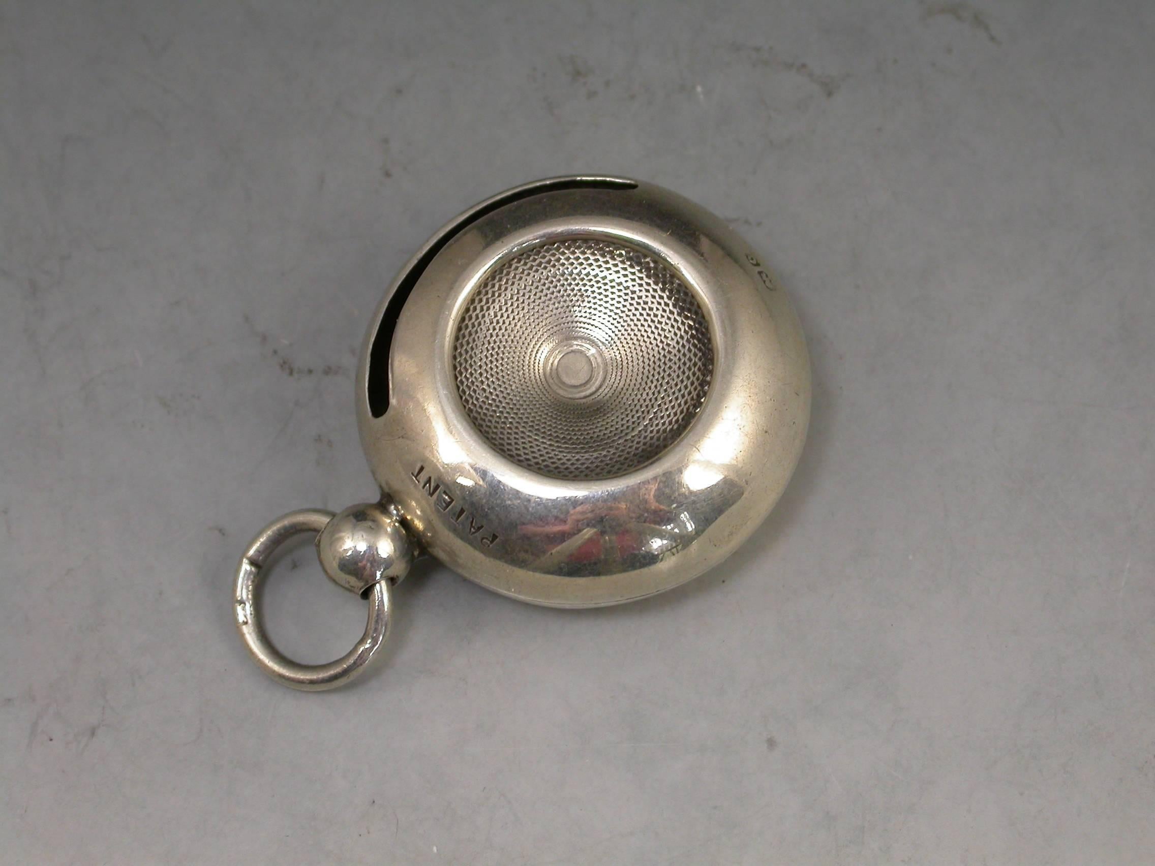 An unusual Edwardian silver Sovereign case of compressed circular form with attached suspension ring, an open sprung central sovereign compartment with side loading slot. A patented design.

By I J Evans & Co, Birmingham, 1902

In good condition