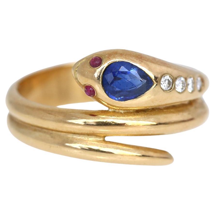 A stunning Edwardian ring of 18 Karat Gold with Sapphire, four Diamonds and Ruby, depicting a small snake.
The serpent, or snake, is one of the oldest and most widespread mythological symbols. The word is derived from Latin serpens, a crawling