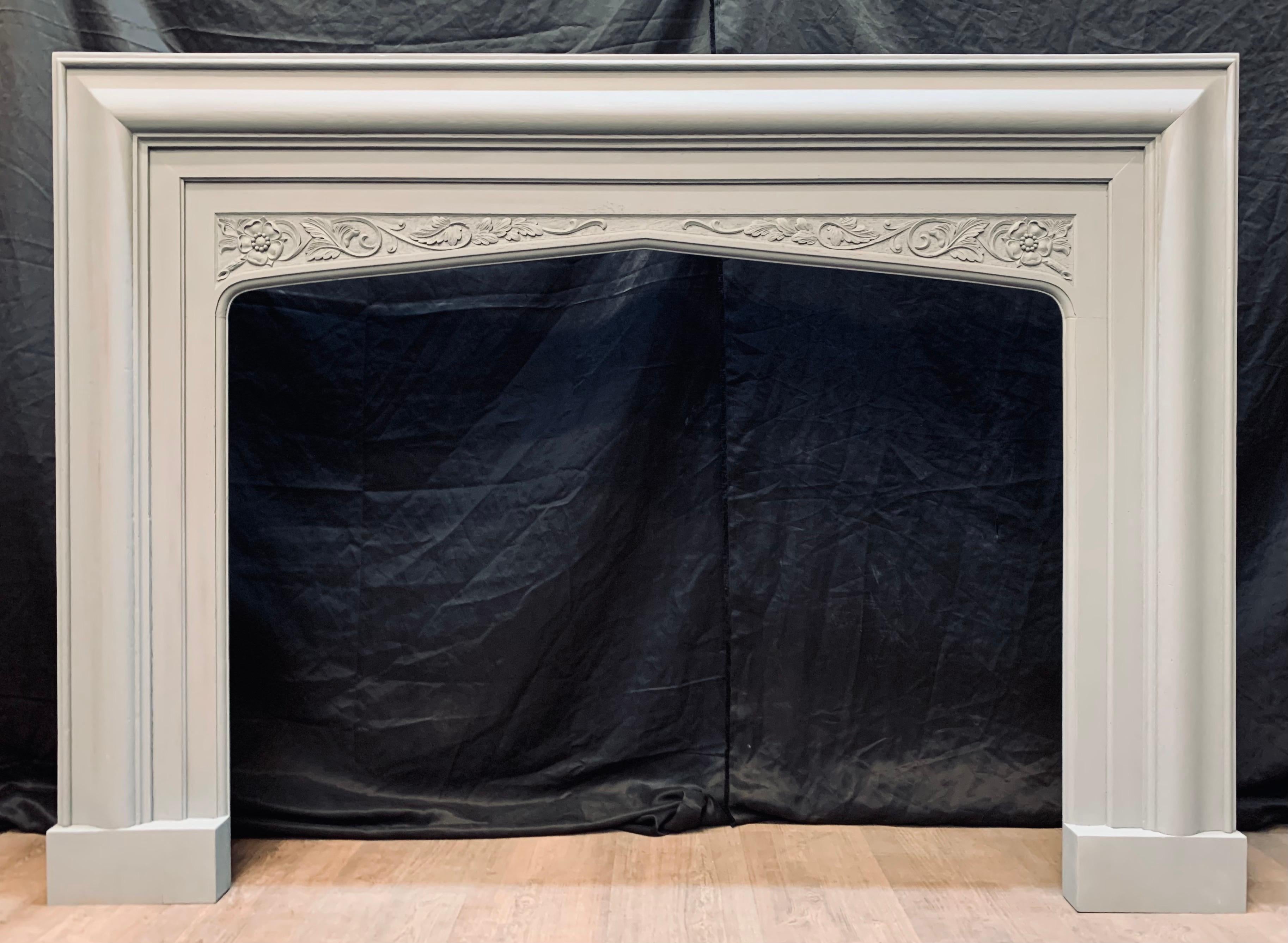A well balanced and wide solid English oak Edwardian Gothic Revival manner bolection fireplace surround. A fairly deep return frame lends this piece a sense of grandeur, a bolection outer frame with an internal lambs tongue slip that creates a