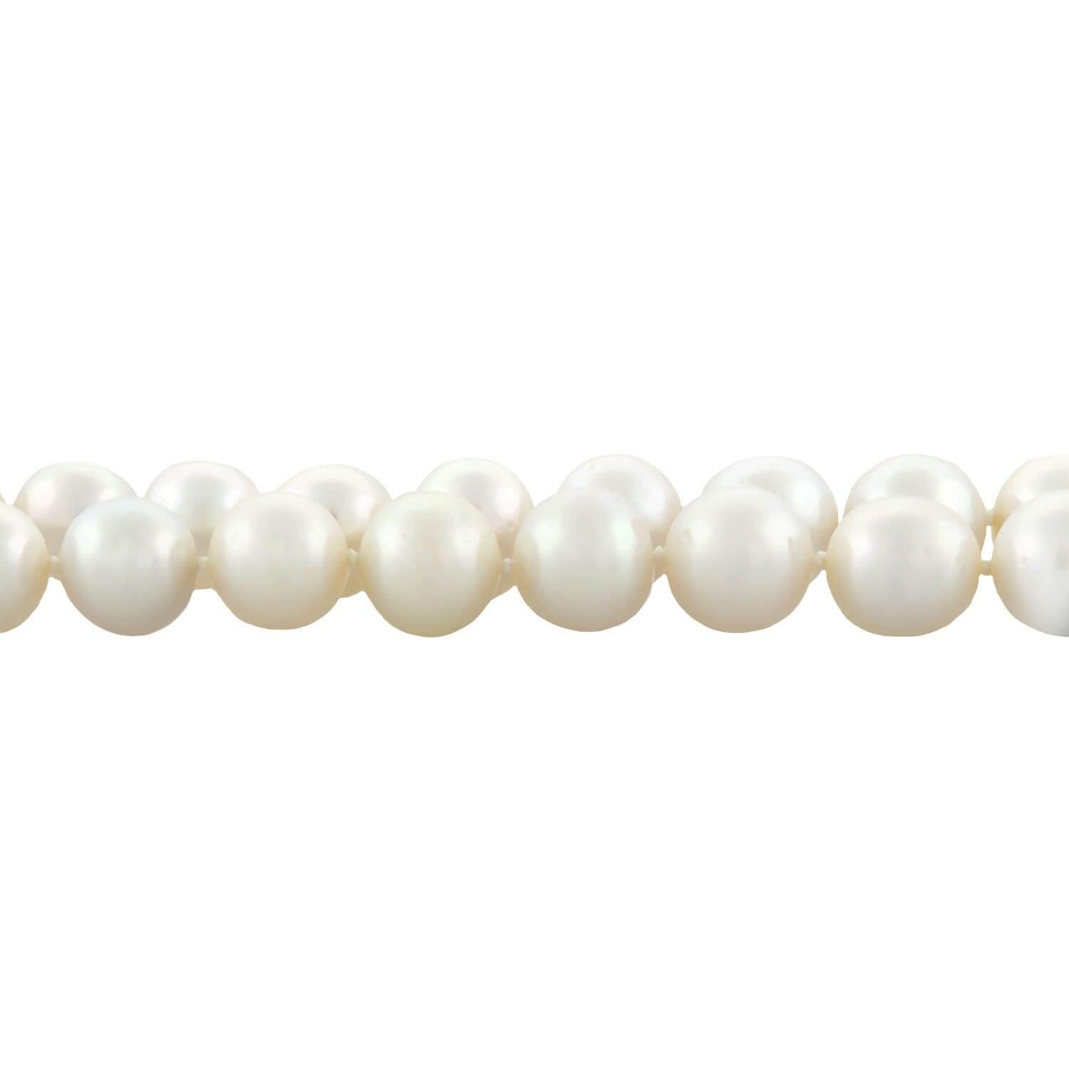 A classically beautiful and very unique South Sea Pearl convertible necklace with a gorgeous diamond and ruby clasp from the Edwardian (ca1910s) era ! This fabulous piece is comprised of a single strand of 35 substantially sized pearls which are