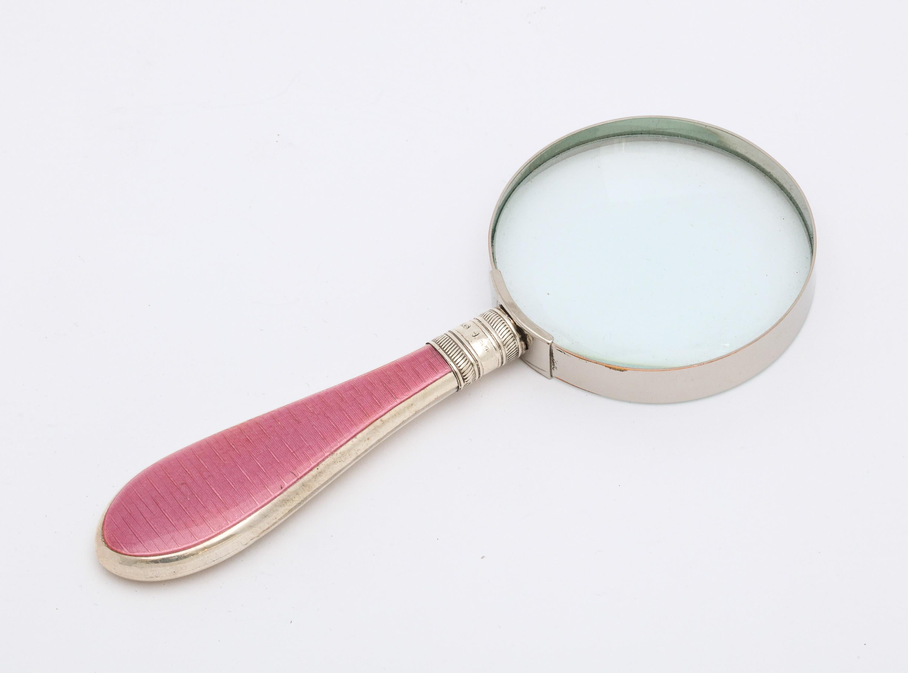Edwardian, sterling silver and deep pink guilloche enamel-mounted magnifying glass, Sheffield, England, year-hallmarked for 1905, James Scholes -maker. Glass surround is metal. Enamel is on one side of the handle. Measures 6 1/2 inches long x 2 1/8