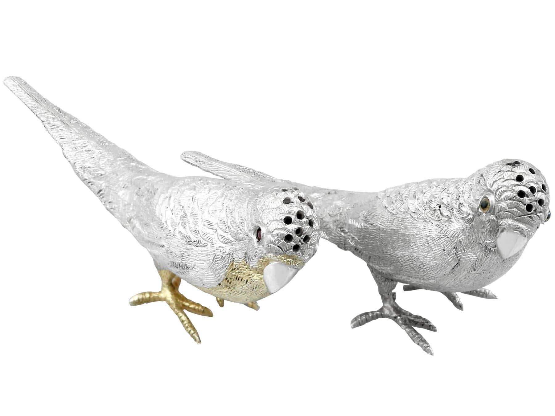 An exceptional, fine and impressive, pair of antique Edwardian English cast sterling silver pepper shakers modelled in the form of budgerigars; an addition to our collectable silver collection.

These exceptional antique cast sterling silver peppers