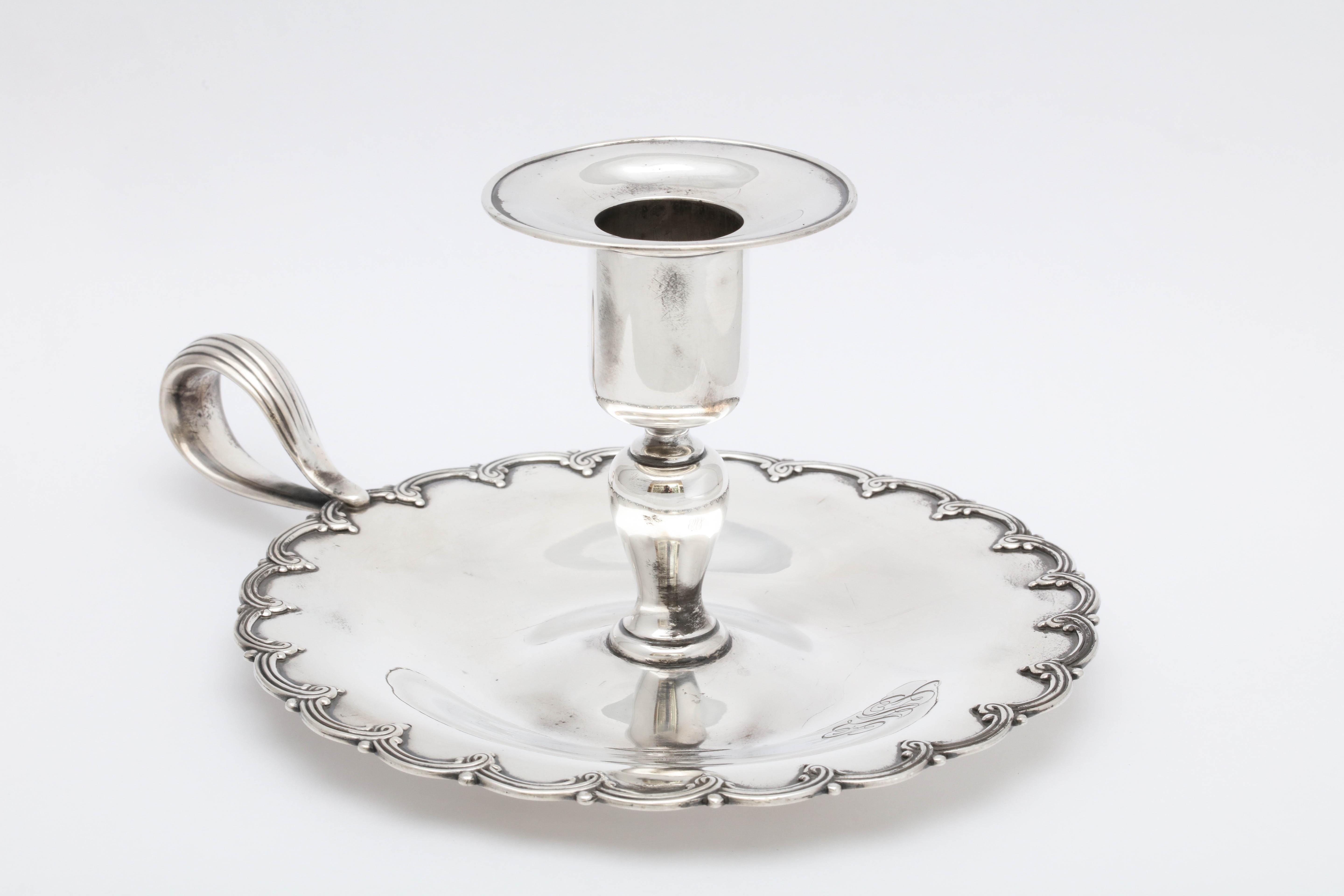 Edwardian, sterling silver chamber stick, Tiffany and Company, New York, inventory marked for 1902-1903. Measures 4 inches high x 5 1/2 inches in diameter x 7 1/4 inches across from handle to outer edge. Weighs 6.255 troy ounces. Scalloped border.