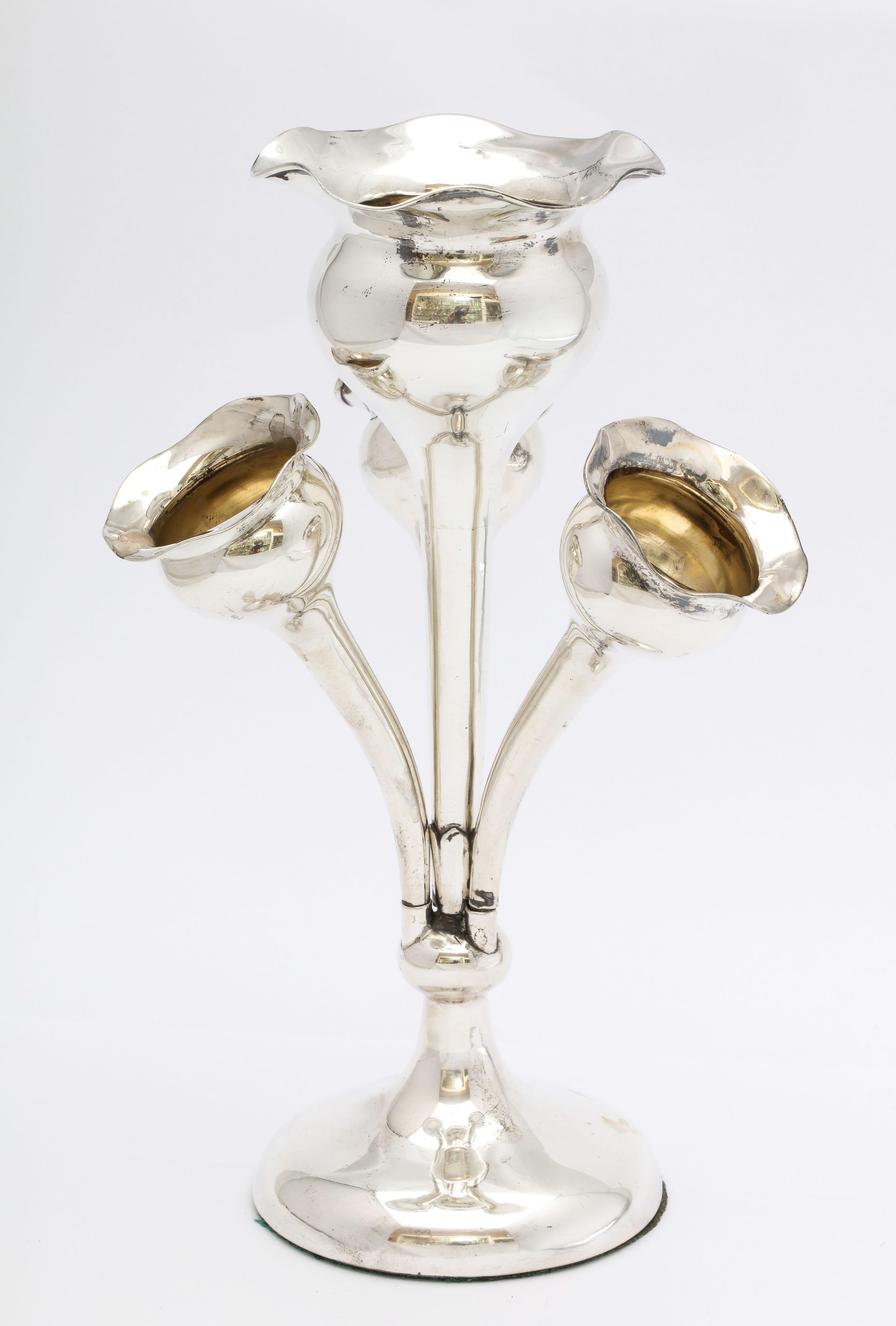 Lovely Edwardian, sterling silver epergne, Birmingham, England, 1910. Three of the flower - form vases are removable. Measures 7 1/2 inches high (at highest point) x 5 1/4 inches across (from smaller vase to smaller vase) x 2 3/4 inches diameter