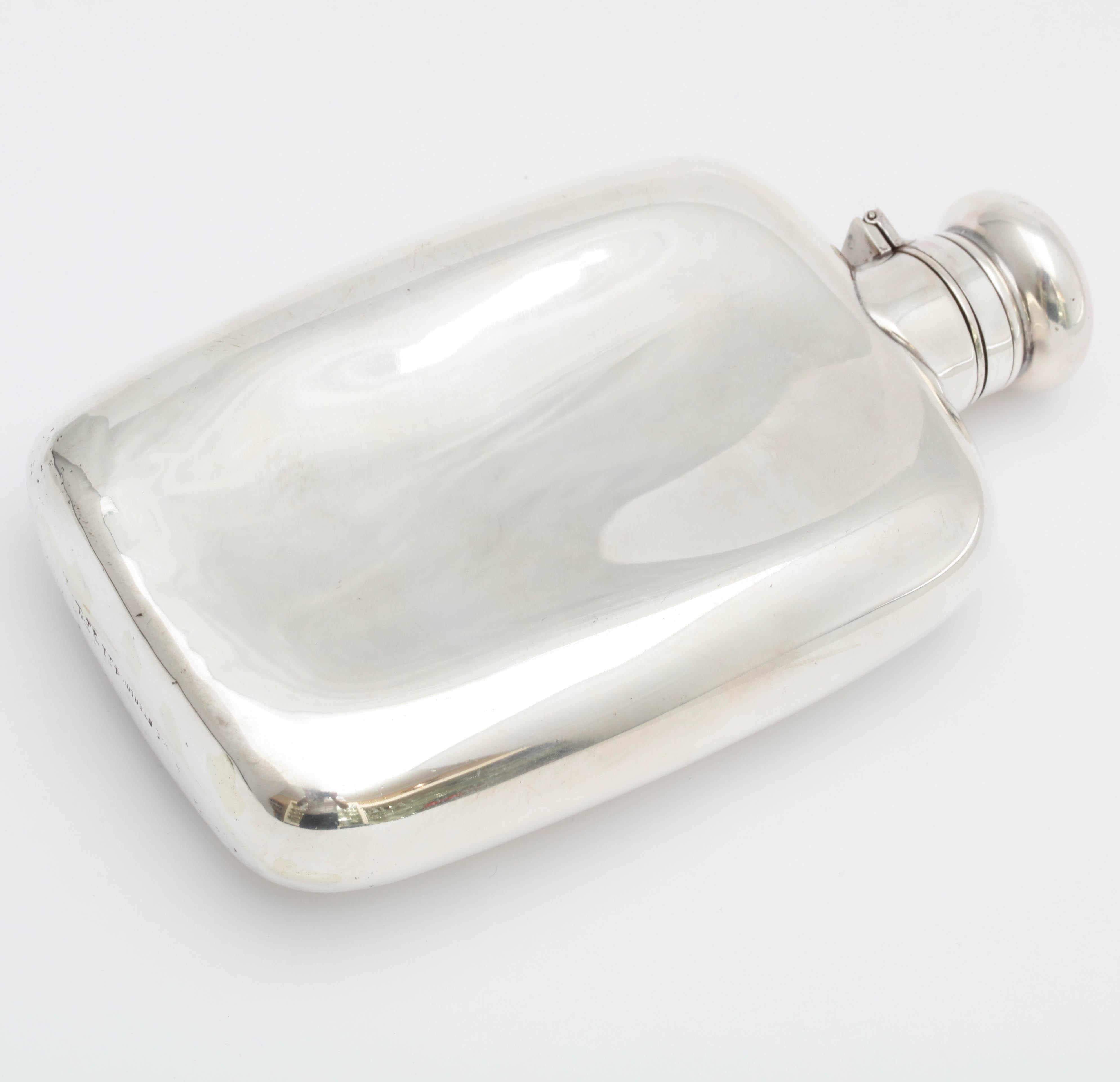 Edwardian, sterling silver flask with hinged lid, R. Wallace & Sons Co., Wallingford, Ct., circa 1910. Measures 5 3/4 inches tall x 3 1/4 inches wide x 1 1/8 inches deep; weighs 4.385 troy ounces. Nice, clean lines. Closure of hinged lid is bayonet