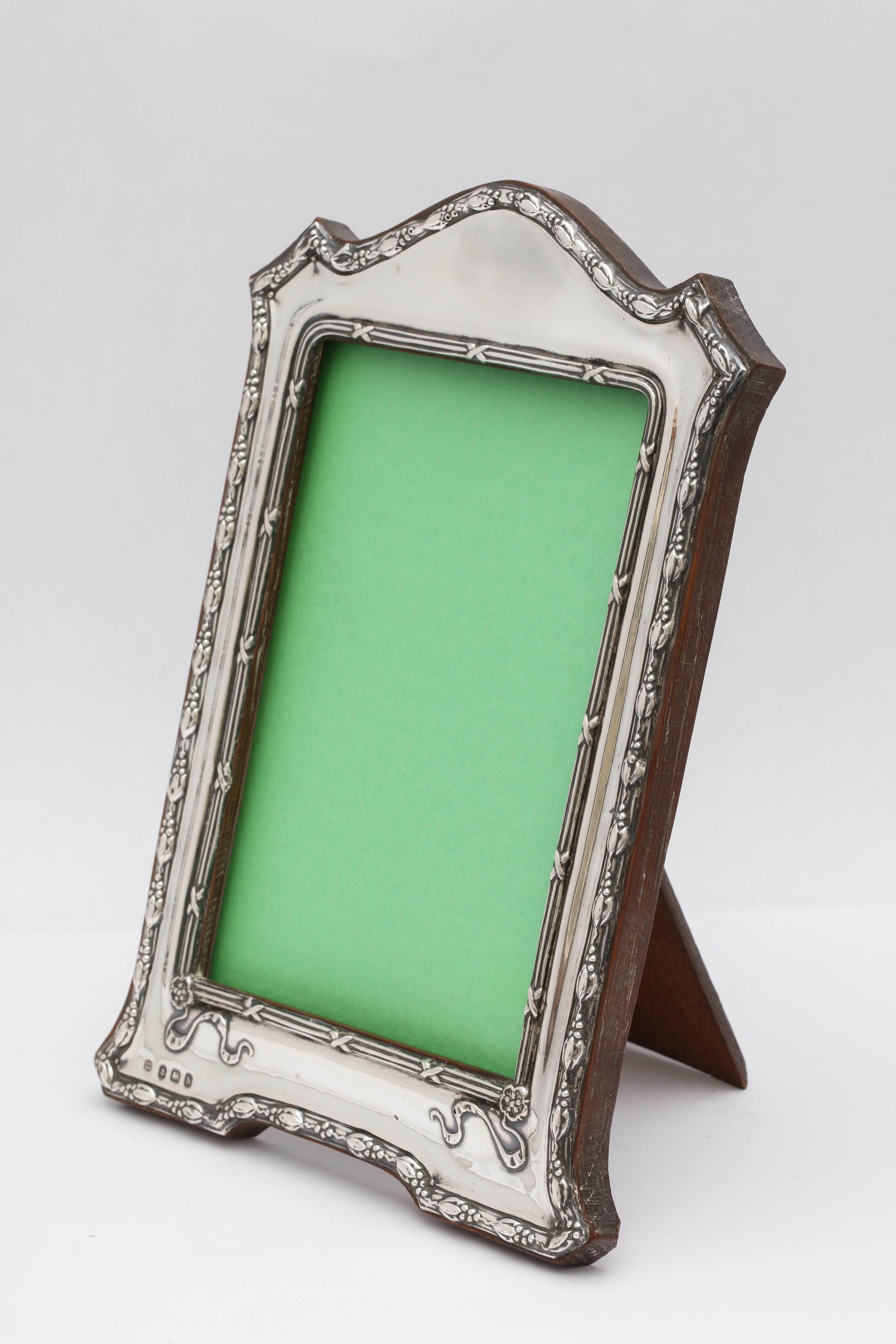 Edwardian, sterling silver, footed, hump top picture frame, Birmingham, England, 1907. Charles S. Green and Co. - makers. Measures: 8 1/2 inches high at highest point x 5 1/2 inches wide at widest point x 4 inches deep when easel is in open