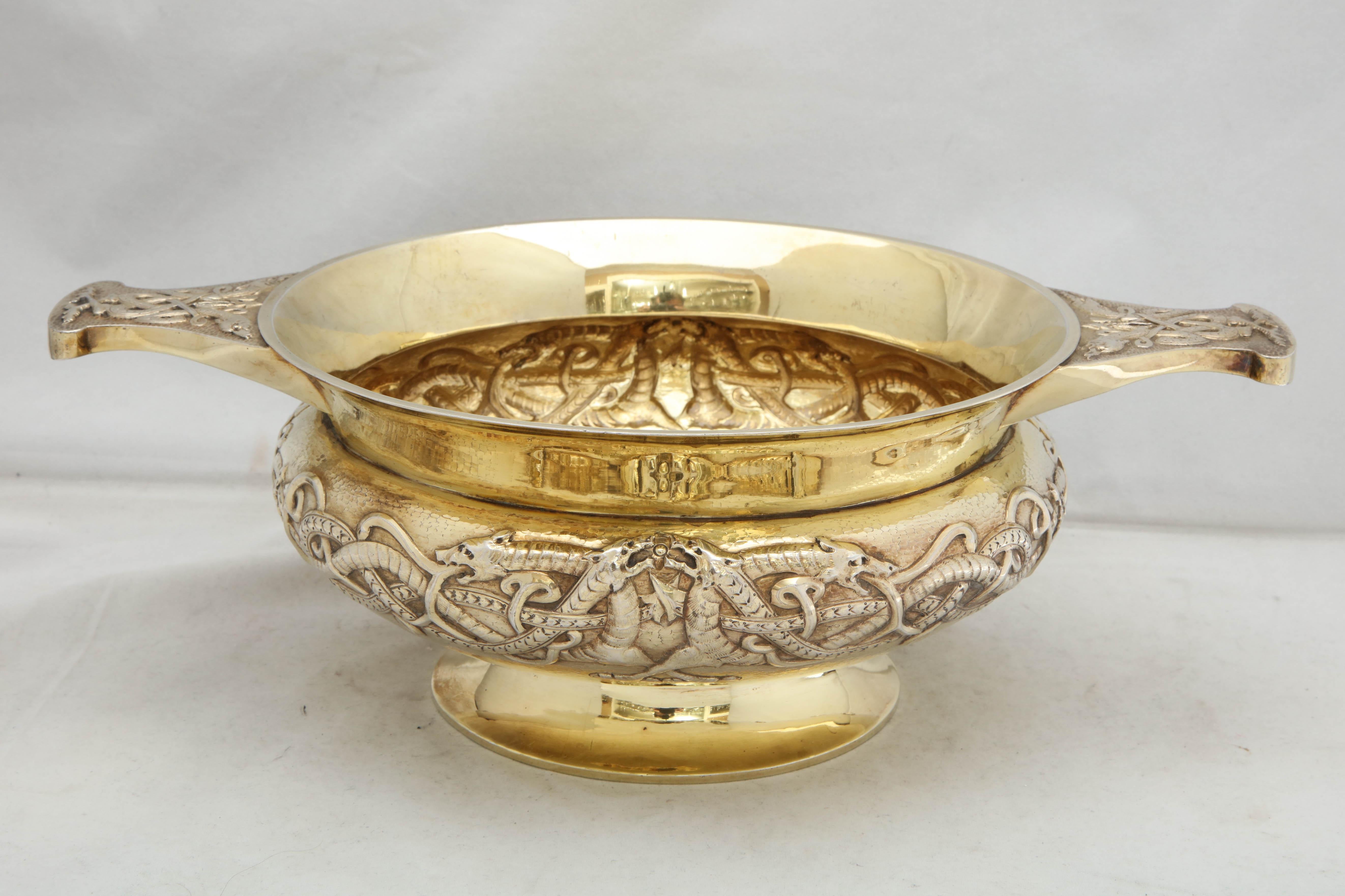 Edwardian period, sterling silver-gilt, Celtic style, two-handled centerpiece bowl, London, 1910, Philip Hanson Abbot - maker. Chased with Celtic designs. Gilded. outside of bowl is lightly hammered. Measures 13 3/4 inches handle to handle x 9 1/2