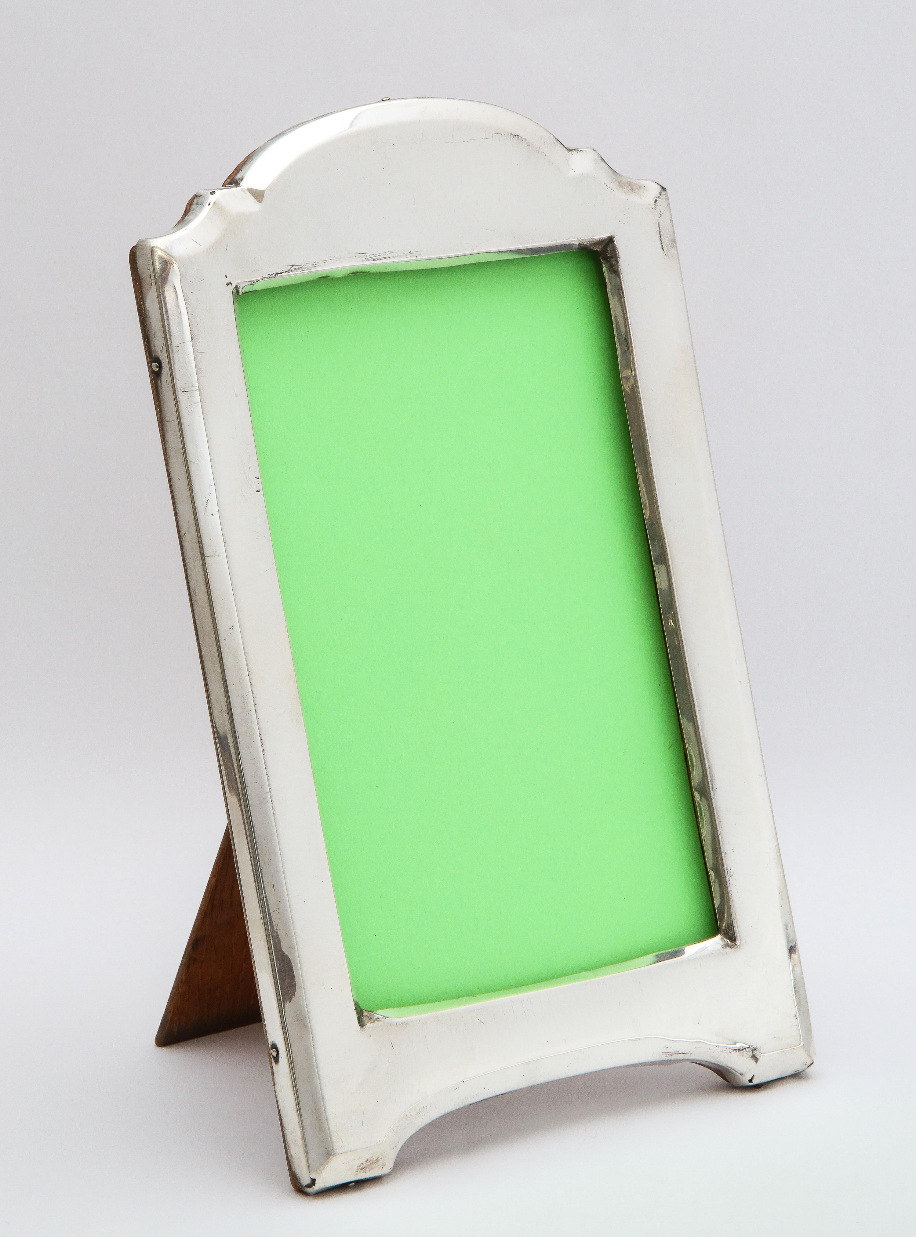 Edwardian, sterling silver, hump-top picture frame with wood back, Birmingham, England, year-hallmarked for 1915, James and John Deakin (James Deakin and Sons) - makers. Measures 8 1/4 inches high at highest point x 5 inches wide x 6 inches deep