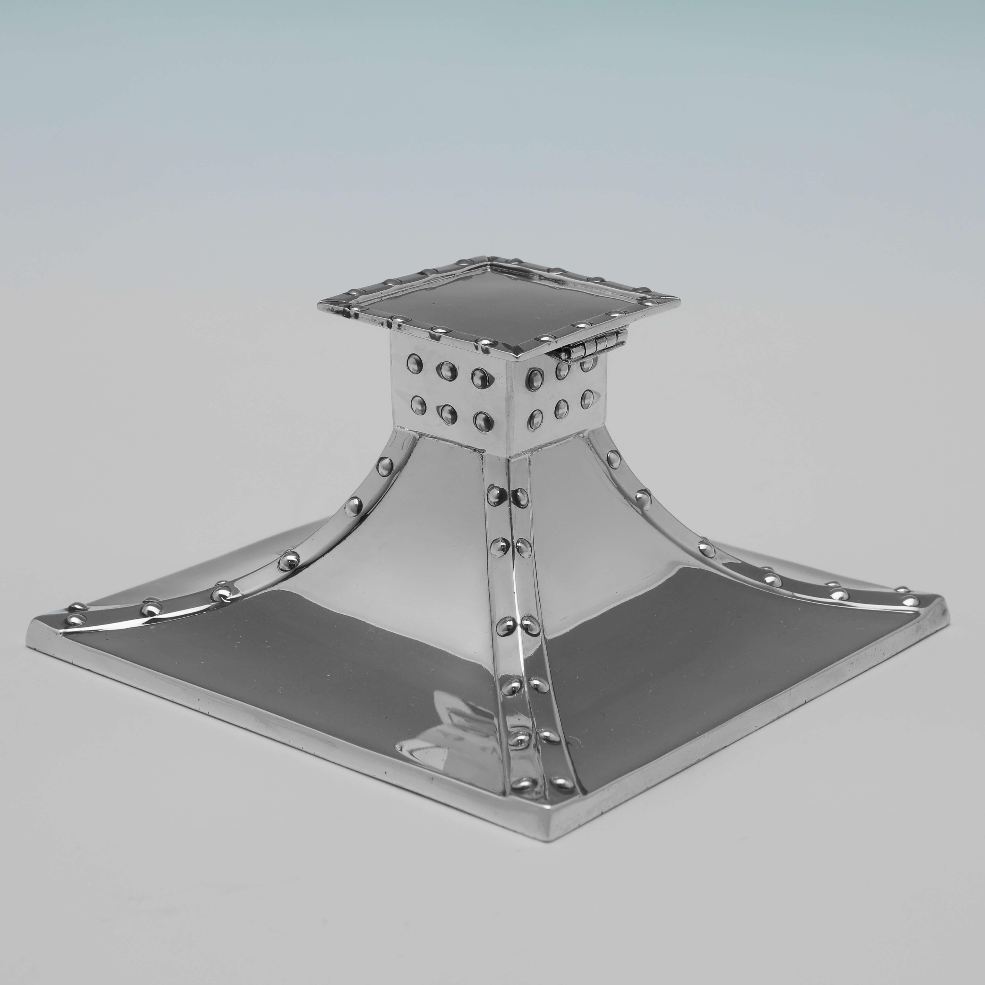Hallmarked in Sheffield in 1904 by James Dixon & Sons, this very stylish, Antique Sterling Silver Ink Stand, is in the rivet design more often seen in candlesticks of this period. 

The ink stand measures 2.25