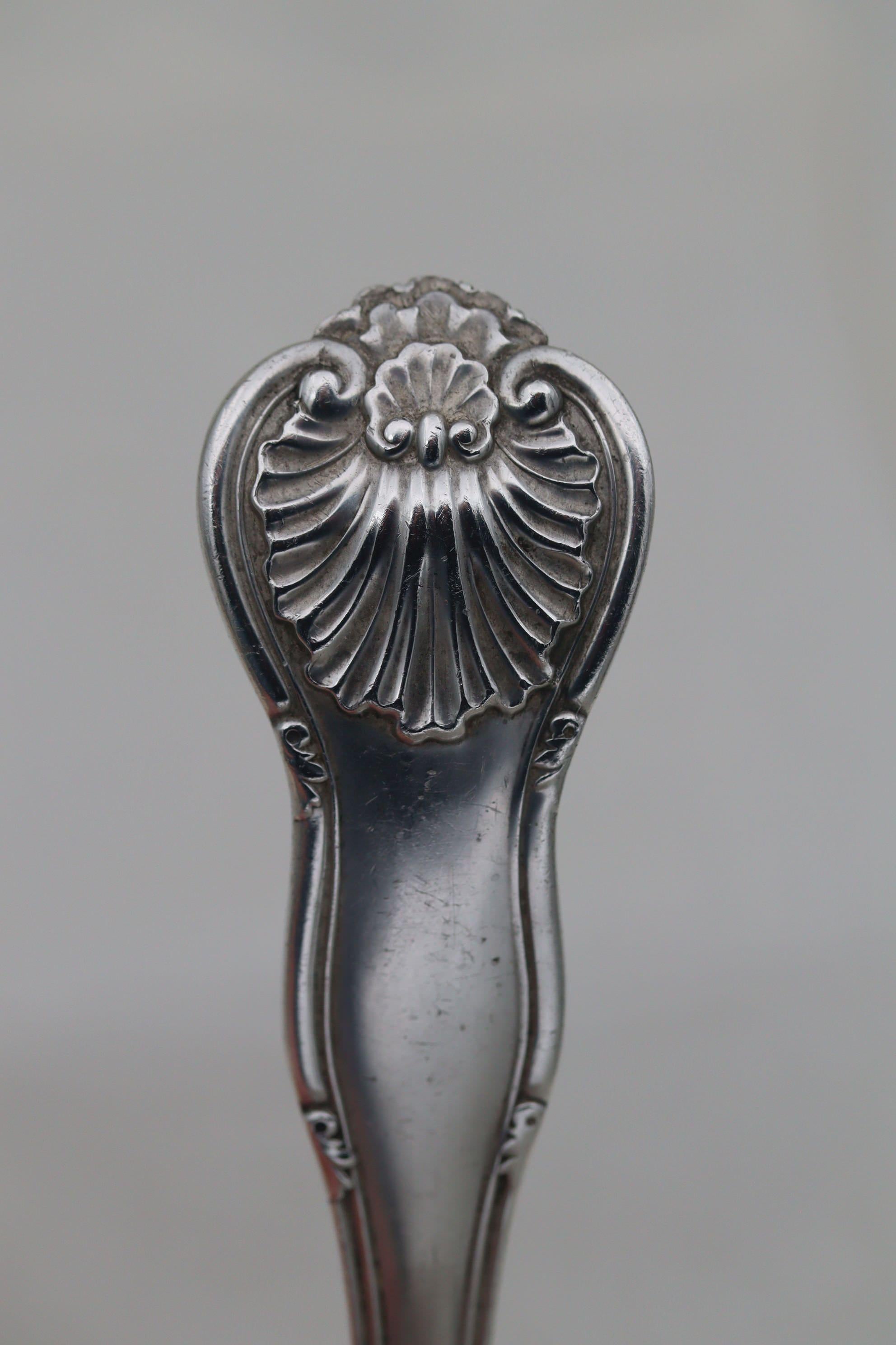 This good quality Edwardian sterling silver soup ladle was made in London in 1911 by the firm of Holland, Aldwinckle and Slater. The decoration is their version of an older pattern known as Hanoverian Military Thread with Shell, where the tip of the
