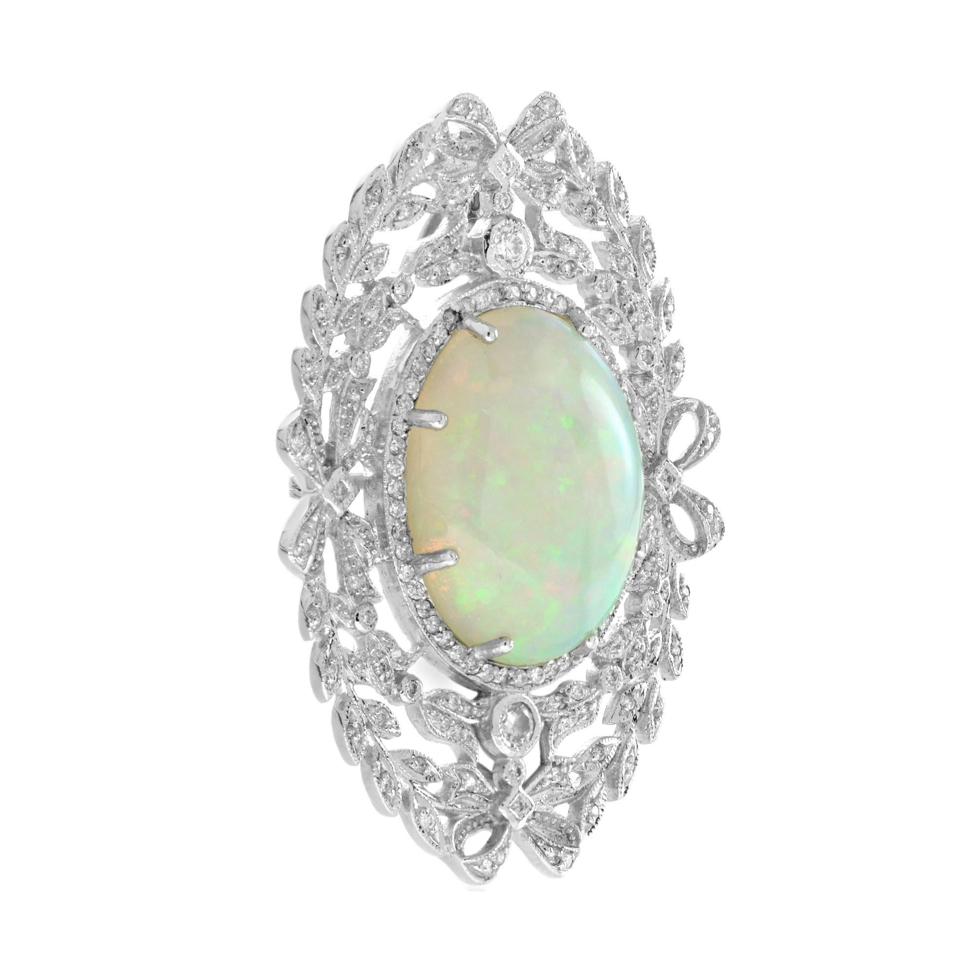 The pendant is of a typically Edwardian design, featuring foliate motifs and an exquisite bow.
Artfully fabricated in 18k white gold, the enchanting gemstone is suffused with an array of gorgeous electric pastel hues, green, orange, and violet. The
